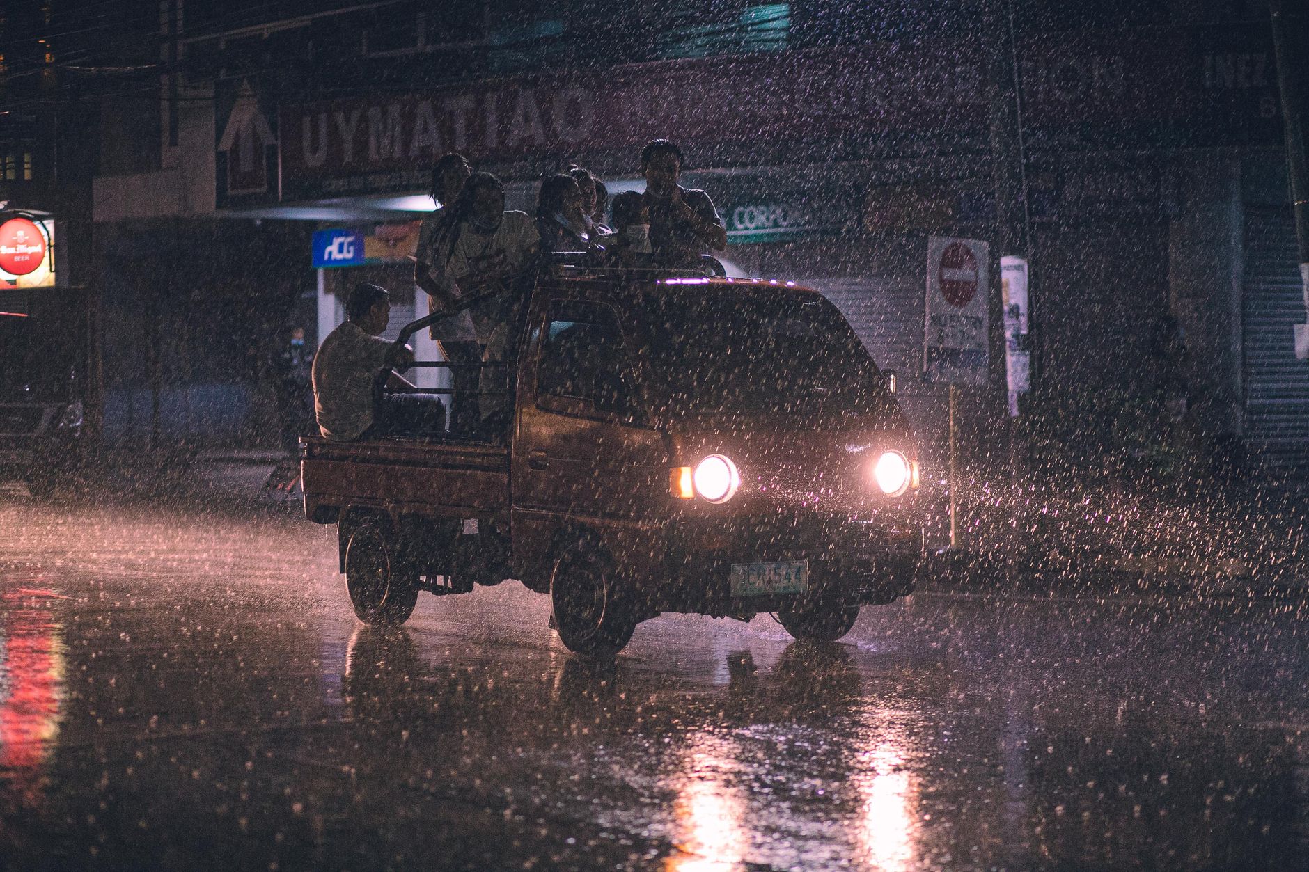 Heavy rain falls on an asphalt surface, demonstrating the need for weatherproof outdoor security robots with a high IP rating.