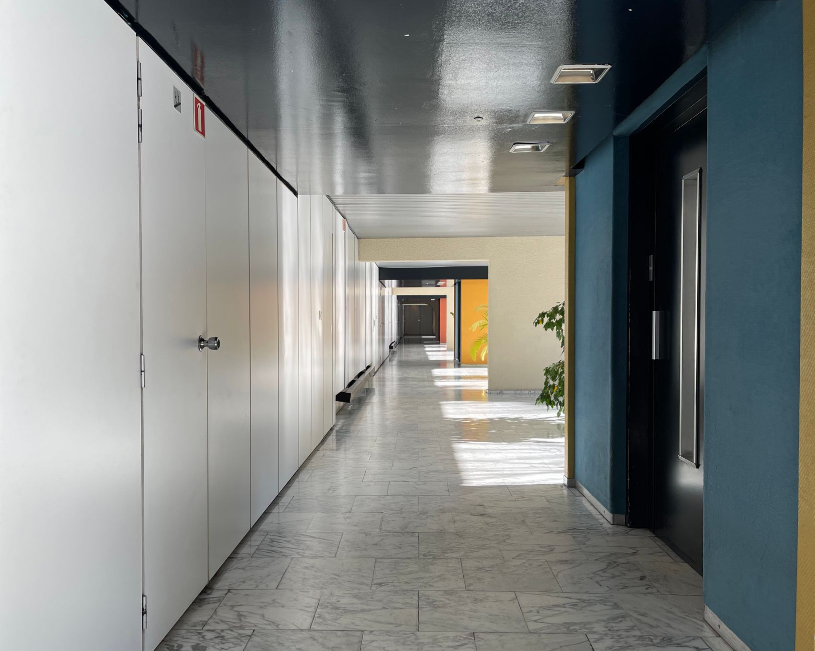 A quiet corridor at night reflects the overnight noise limits many climbing gyms face when full-clean airflow runs after close.