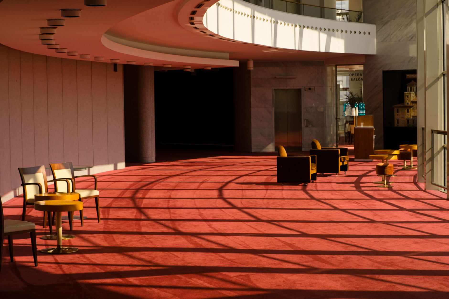 A spacious performing arts center lobby with carpeted and hard-floor areas before audience arrival.