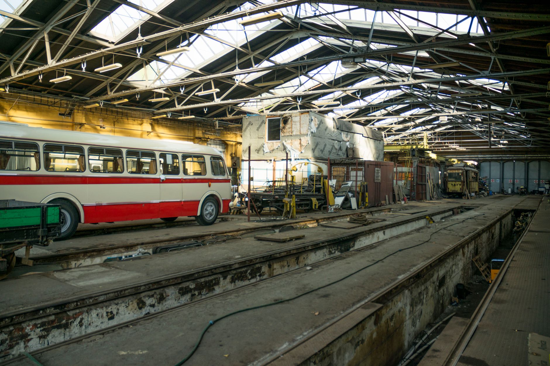 A mechanic inspecting a bus inside a depot, reinforcing the article's emphasis on narrow pilots, repeatable checks, and service support.