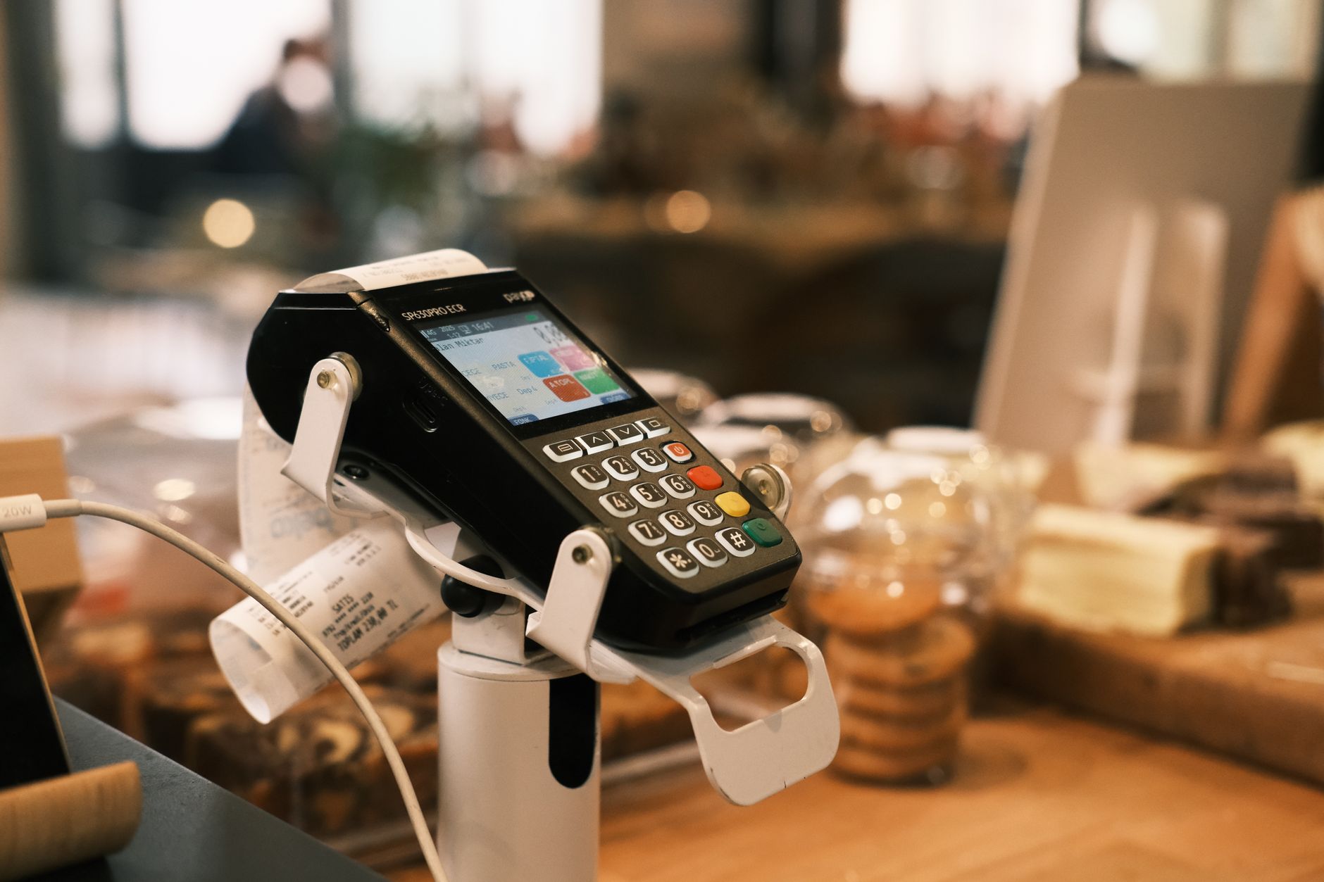 A campus dining checkout scene with payment hardware in view, reflecting how tightly ordering and payment systems are tied to vendor changes.
