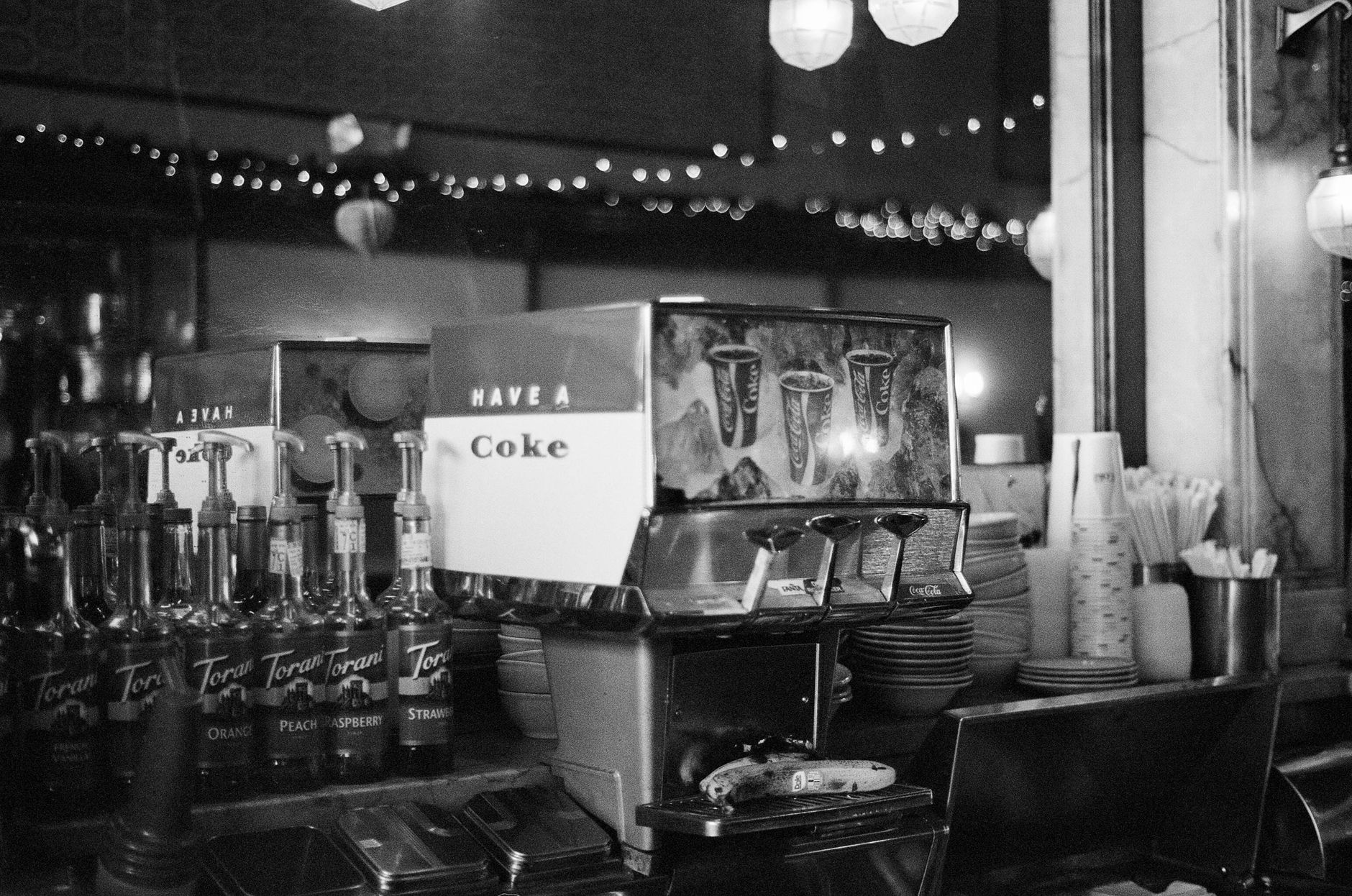 Self-serve drink and coffee area in a convenience store where spills and sticky residue build up quickly during customer traffic.