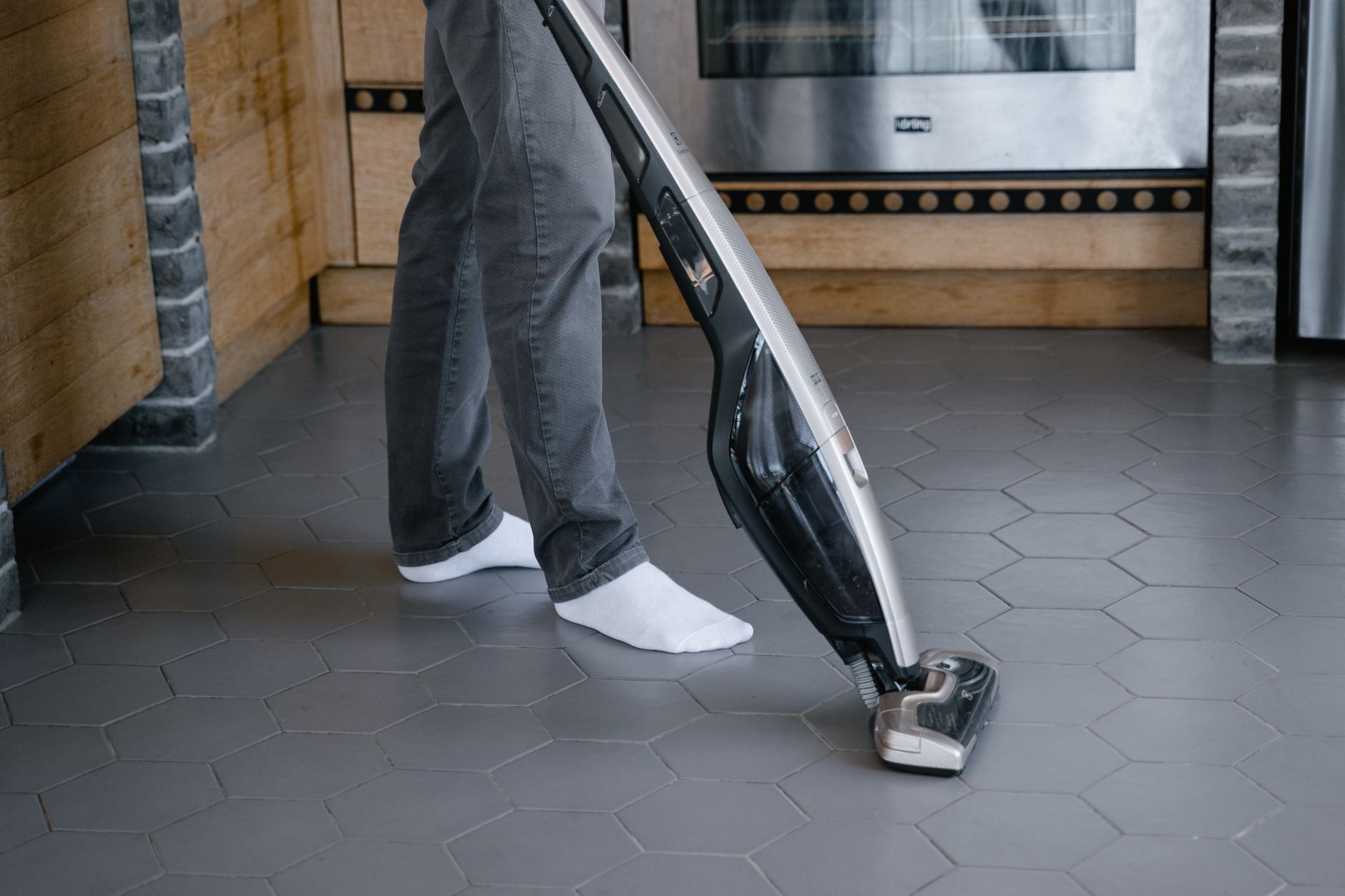 A cleaner vacuuming an indoor staircase that conventional autonomous floor machines cannot service.