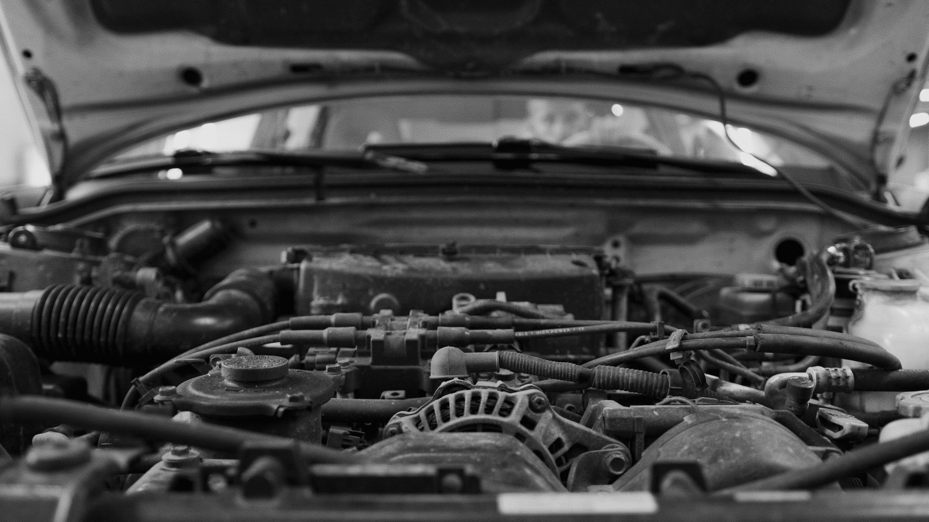 A dealership service area with hoses, tools, and floor obstacles that illustrate why some zones stay manual-first.