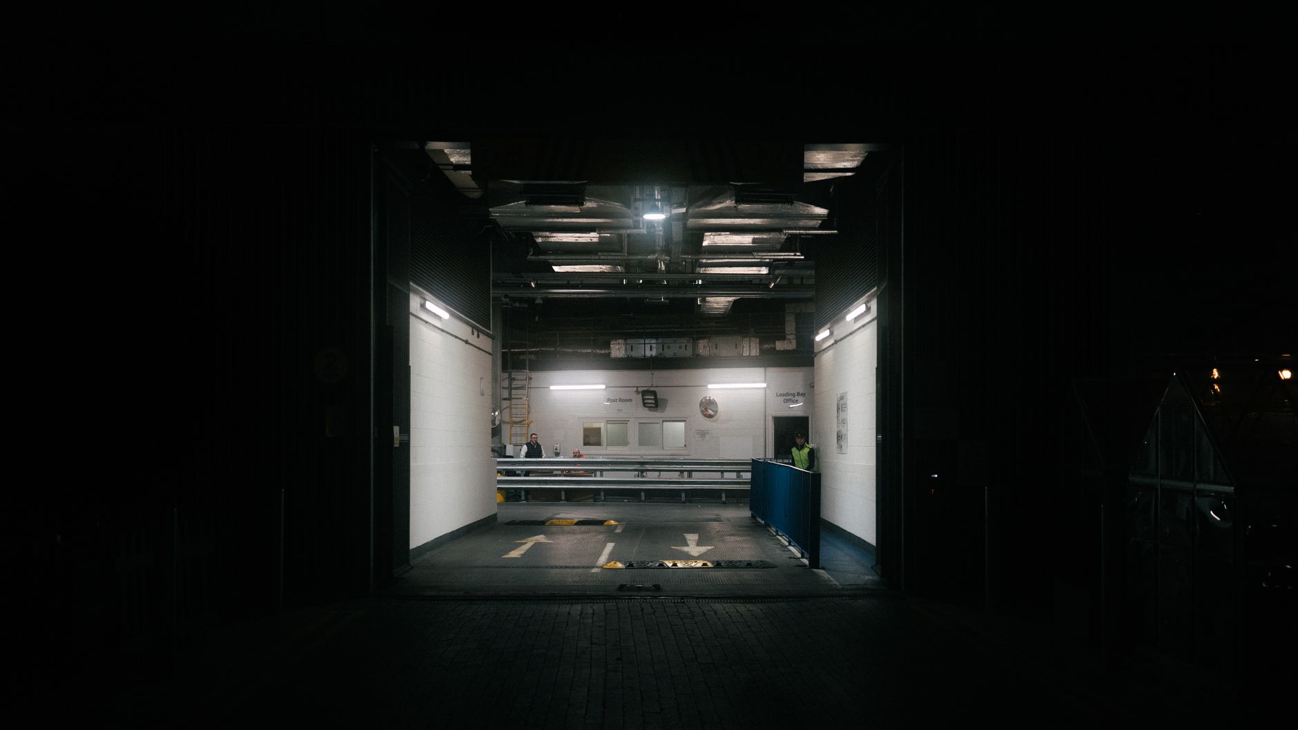 A service counter beside warehouse inventory illustrates the short handoff routes between customer-facing staff and back-of-house storage.