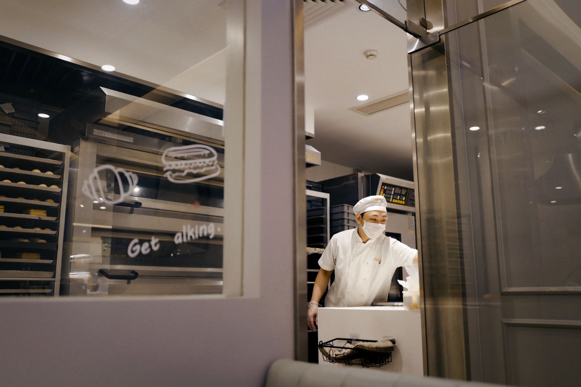 A sanitation worker manually cleaning commercial food-processing equipment.