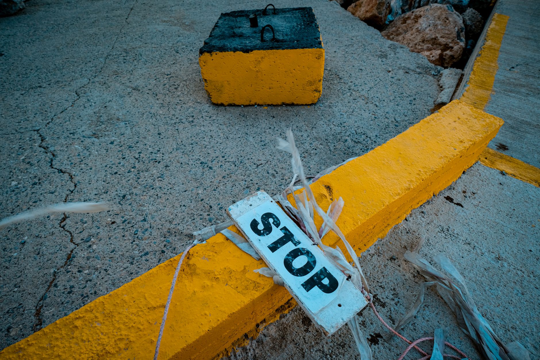 A damaged sidewalk and uneven curb illustrate the obstacles that complicate last-meter deliveries.