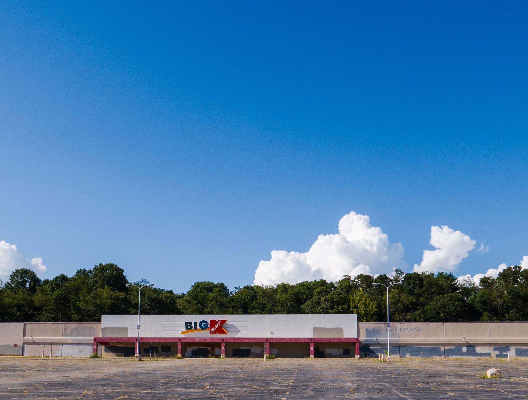 A vacant commercial building with an empty parking area, illustrating the kind of quiet property that can attract after-hours copper theft.