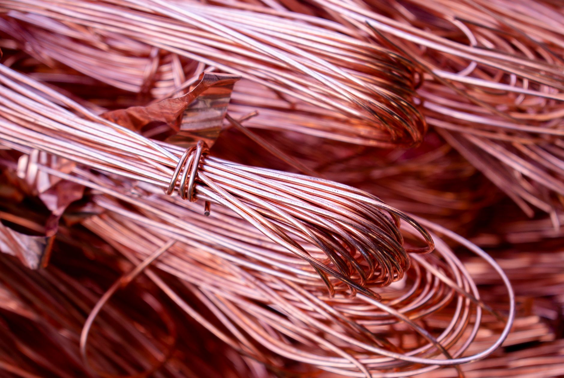 A close-up of thick, coiled copper wire, representing the valuable material that robotic security systems help protect from theft at utility sites.