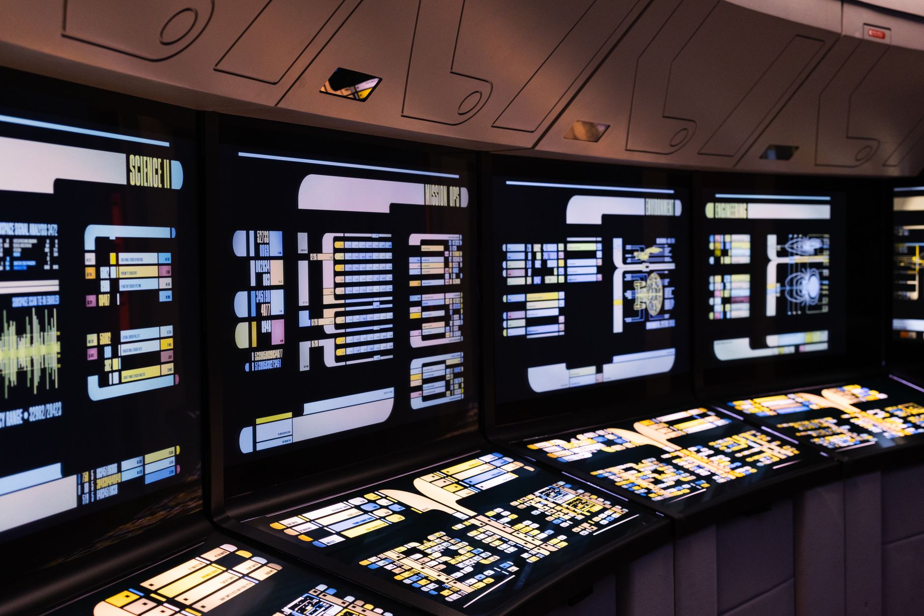 An operations manager views a complex data dashboard on a large screen, representing the centralized monitoring of a robot fleet.