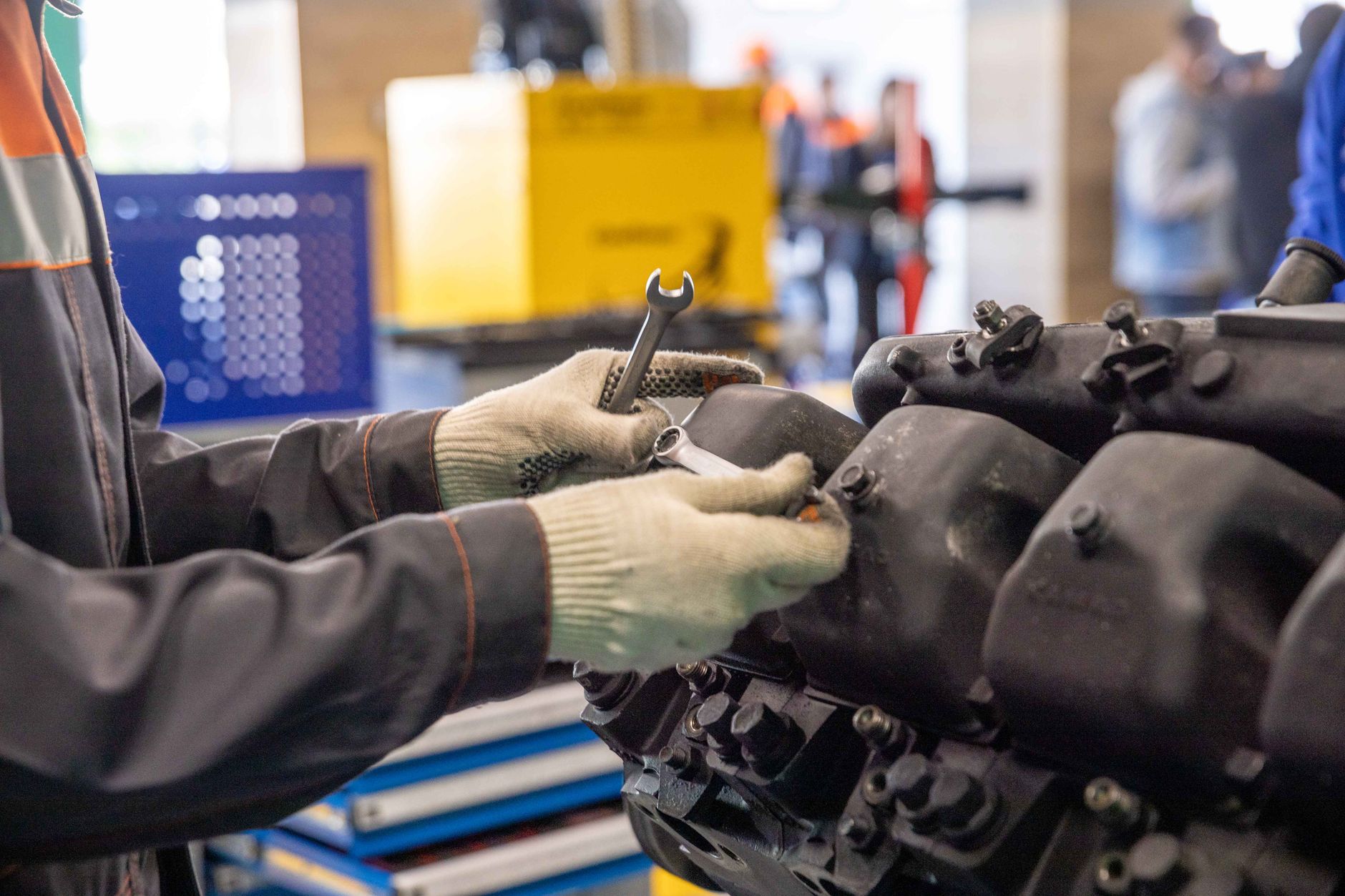 A technician carefully inspects the internal components of a complex machine, illustrating the hands-on repair work that is sped up by remote diagnostics.
