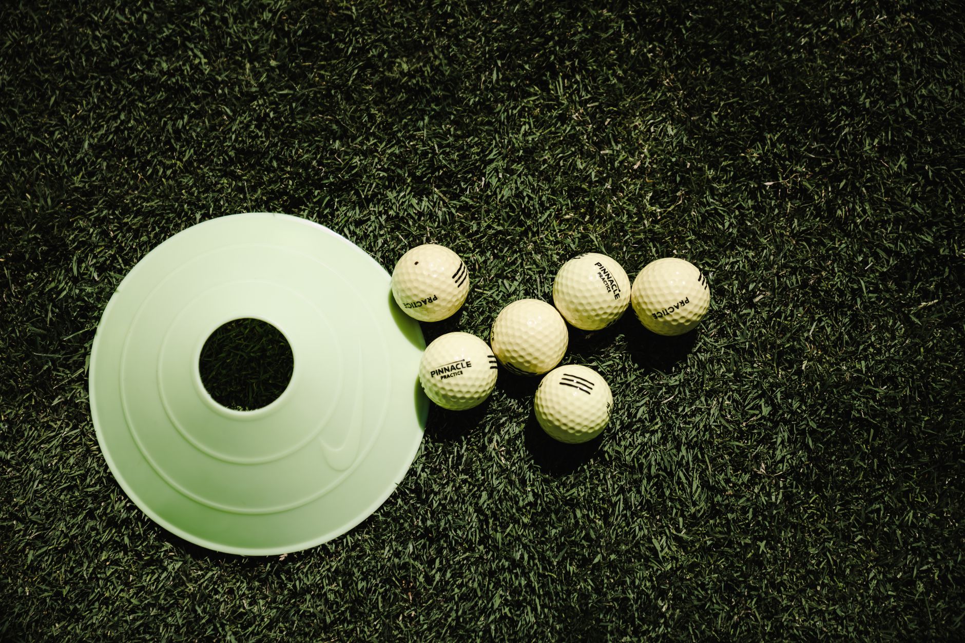Cones and stakes marking a temporary path across open turf