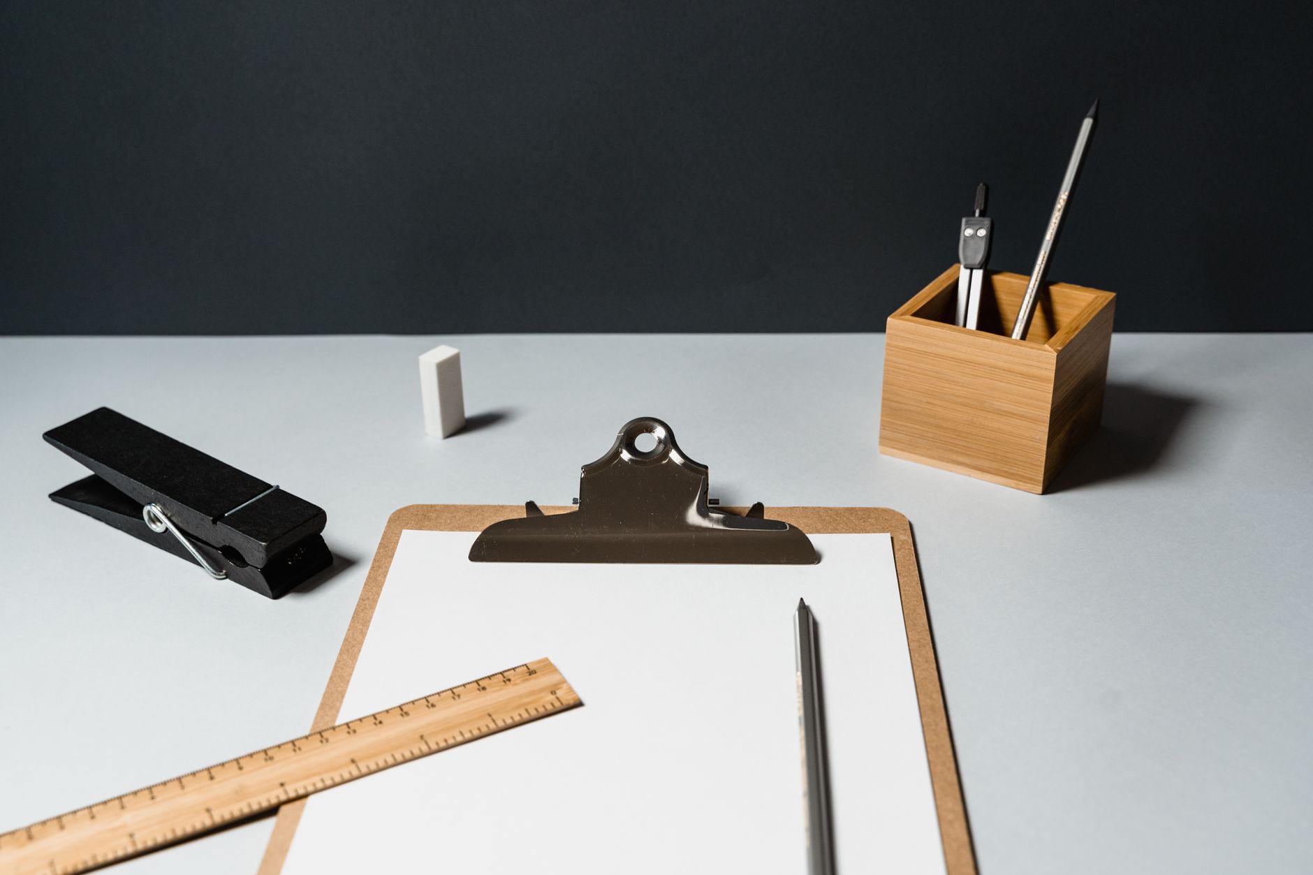 A clipboard and logbook lying on a desk, representing the runner logs a team keeps before comparing measured results with vendor projections.