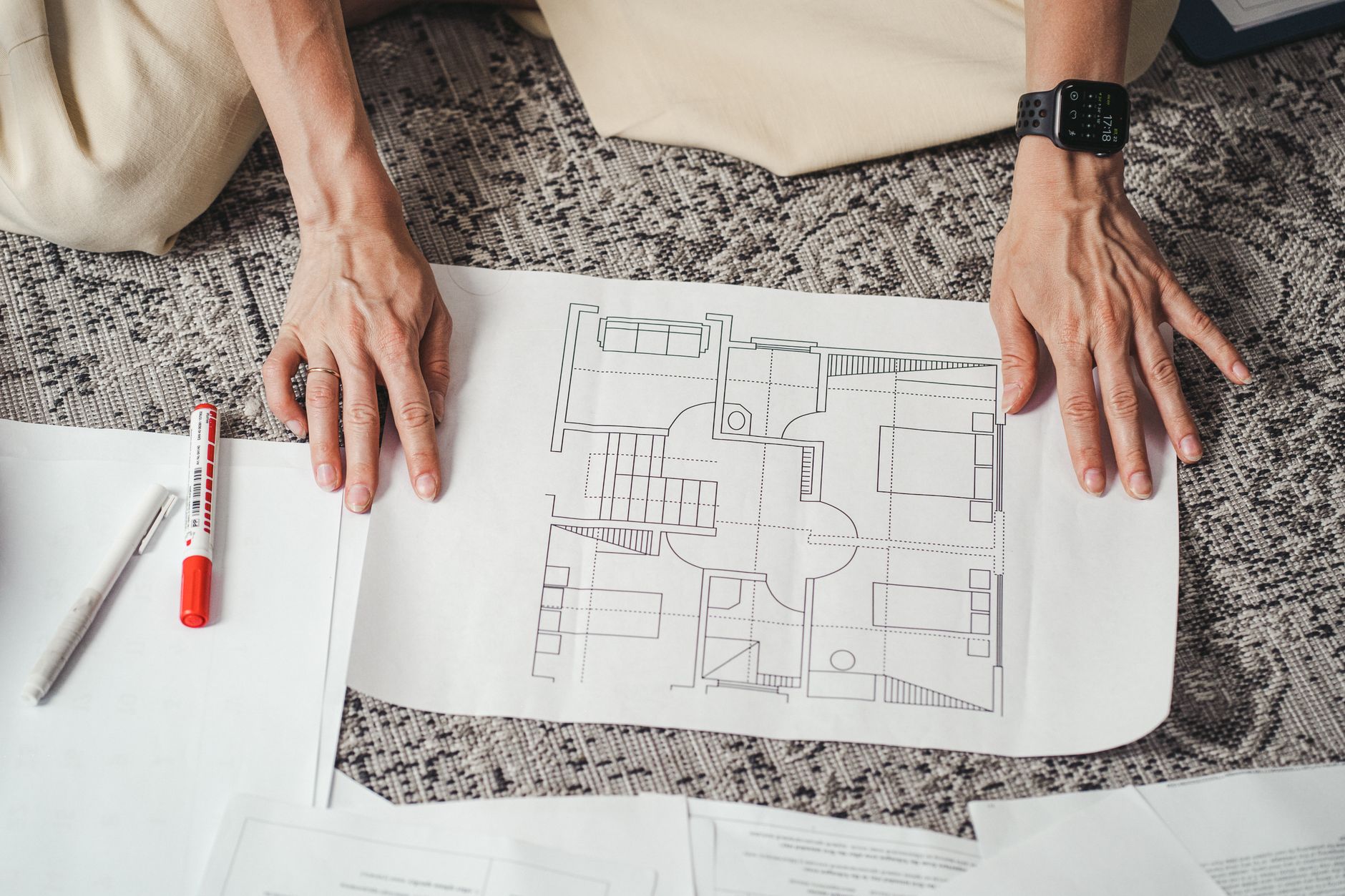 A building floor plan spread across a table, showing the corridors, doors and elevators that a site assessment maps.