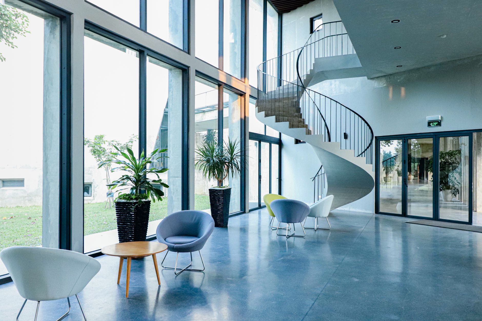 An open, polished hard-floor lobby and corridor where a scheduled floor cleaning pass can run between visitor sessions.