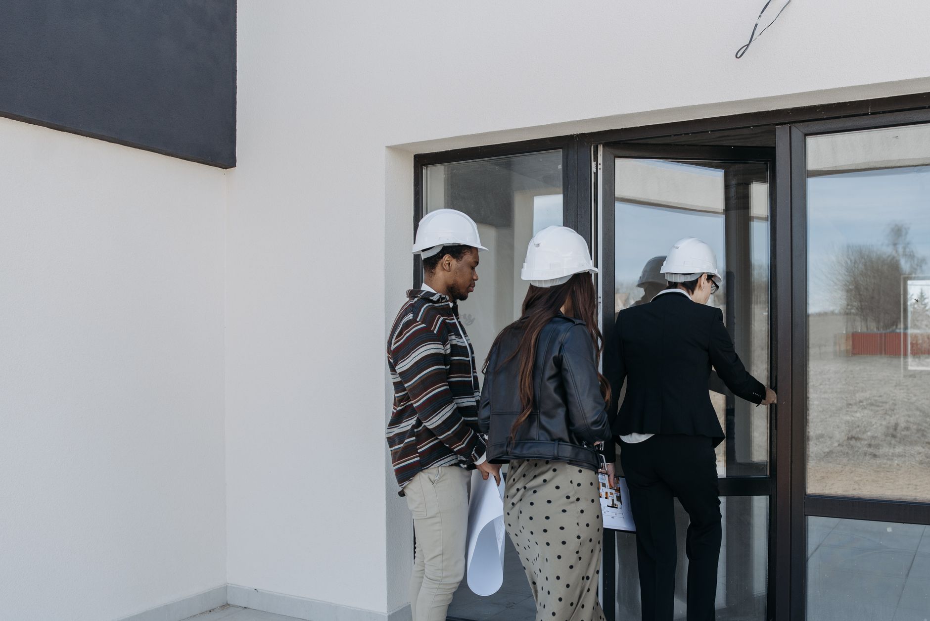 A facility manager walking a site with a clipboard during an assessment of floors, aisles and cleaning routes.