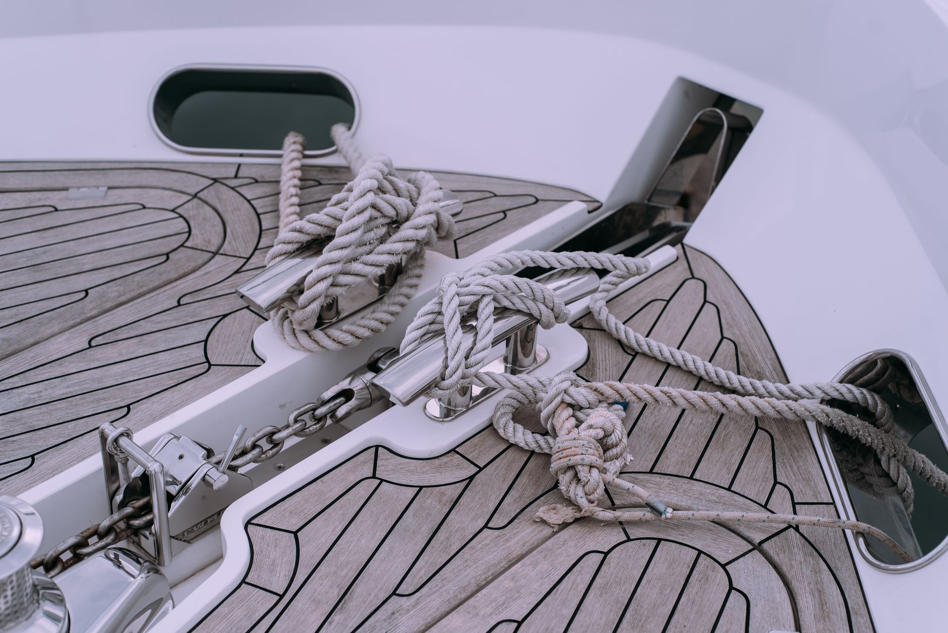 A curved fiberglass boat deck illustrates the reach and tool-angle challenges involved in polishing complex surfaces.
