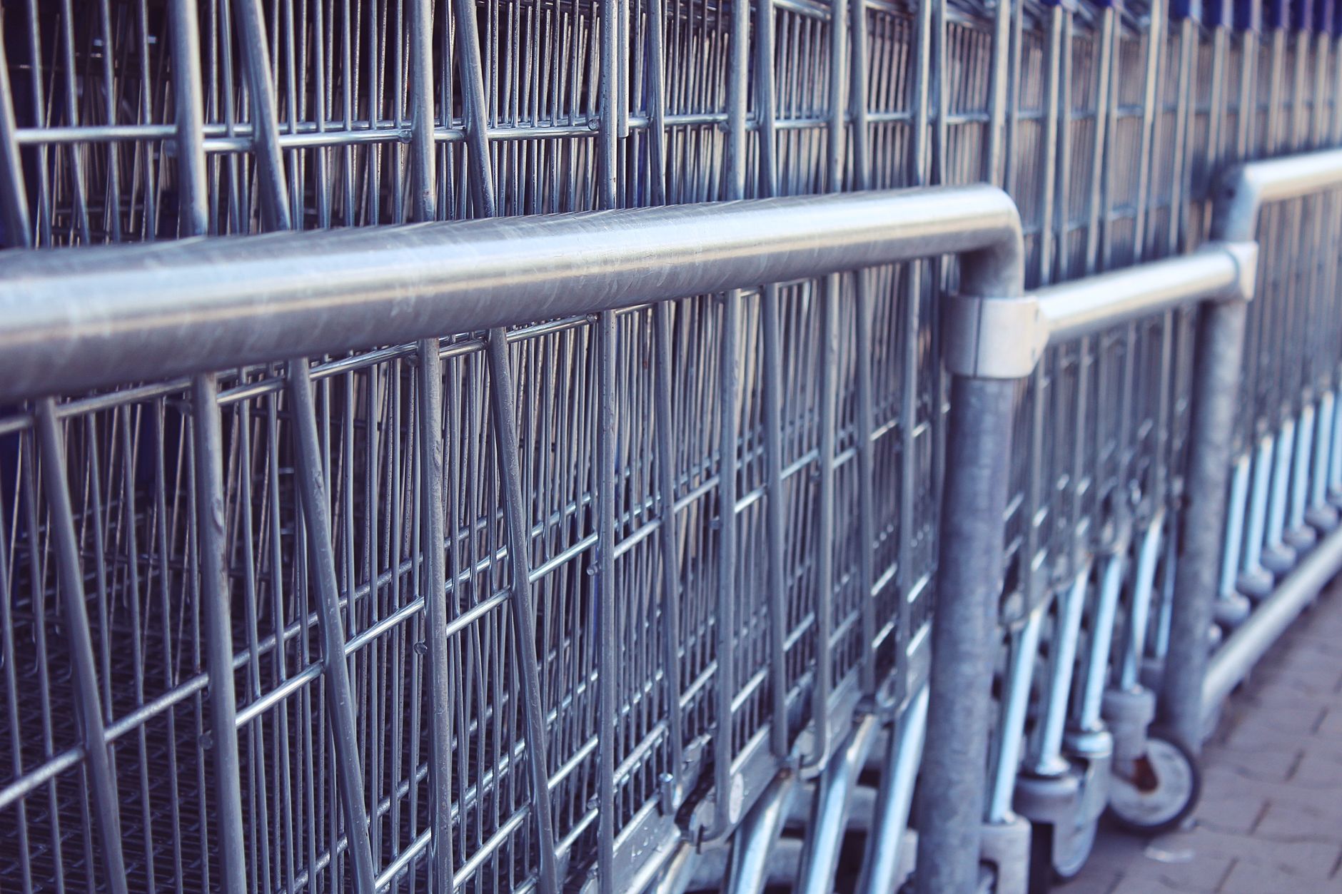 Rows of stainless steel service carts and prep tables inside a commercial catering kitchen, showing the cart-heavy environment an airline caterer must map before selecting AMRs.