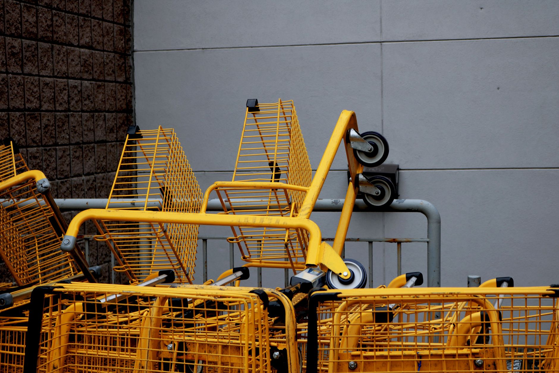 Metal carts and tote racks illustrate the removable carriers that must remain electrically bonded during material transport.