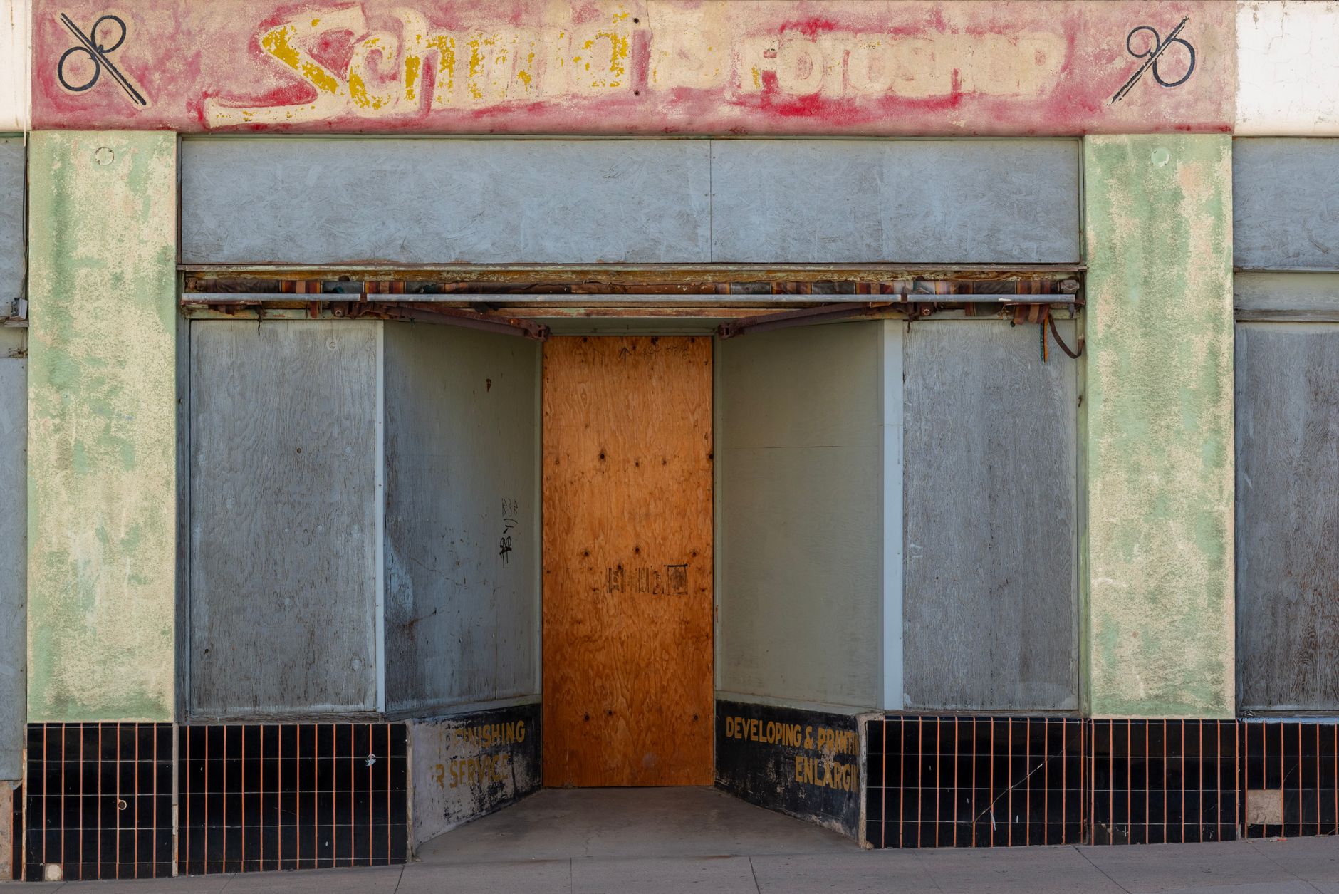 A boarded or darkened storefront entrance illustrates the kind of vacancy condition that can trigger insurer scrutiny and stricter property checks.