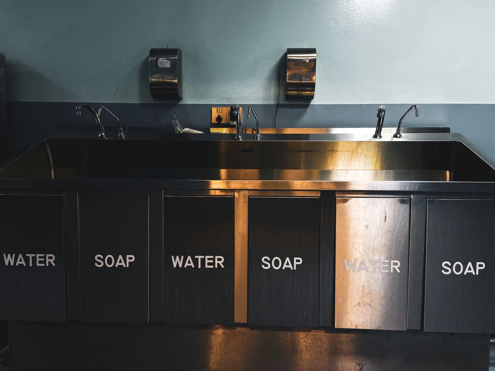 A handwashing station in a production setting, reinforcing the hygiene controls that cannabis facilities now have to document and follow.