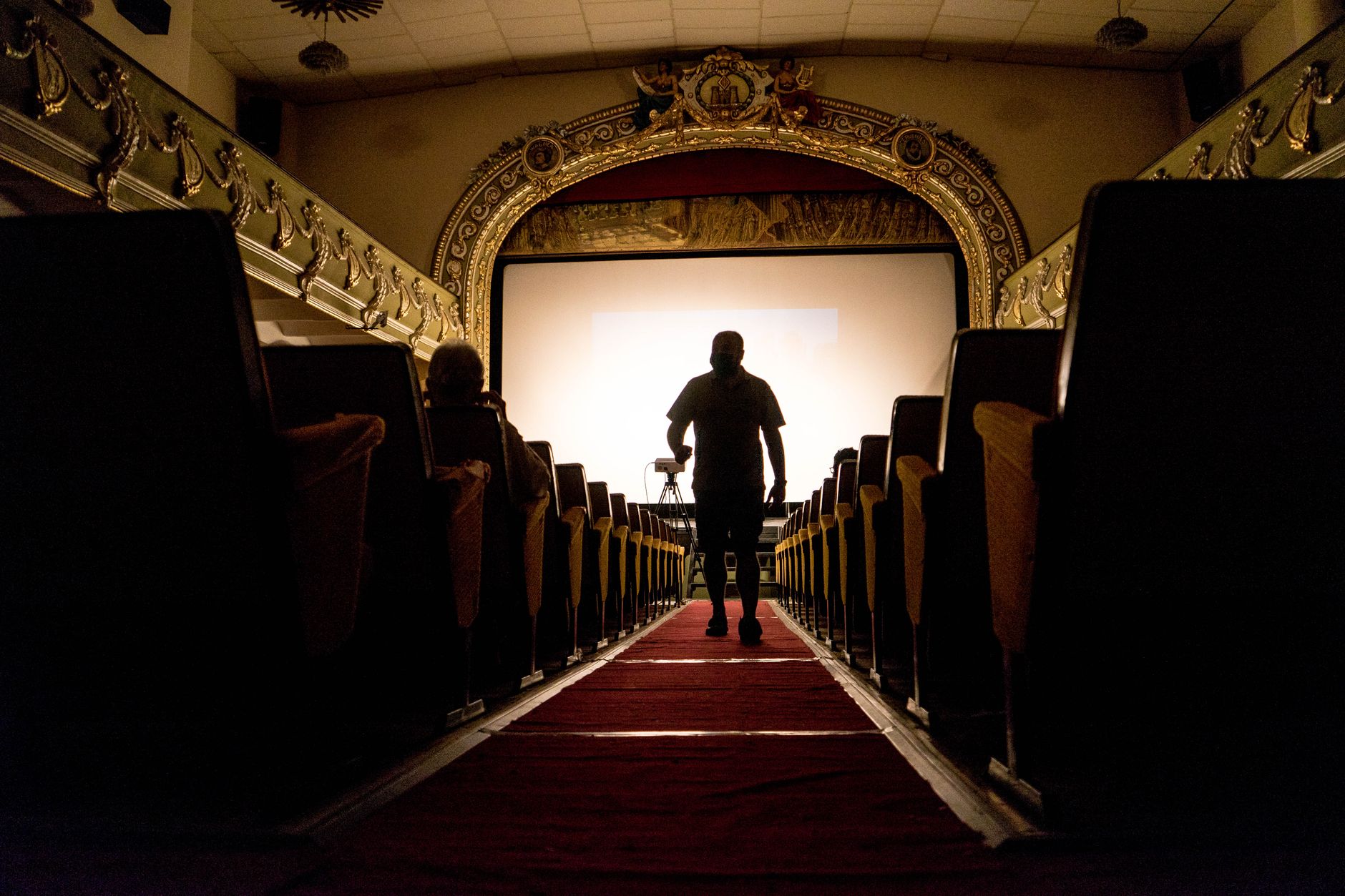 Carpeted queuing lanes in a cinema lobby showing mixed flooring near the box office.