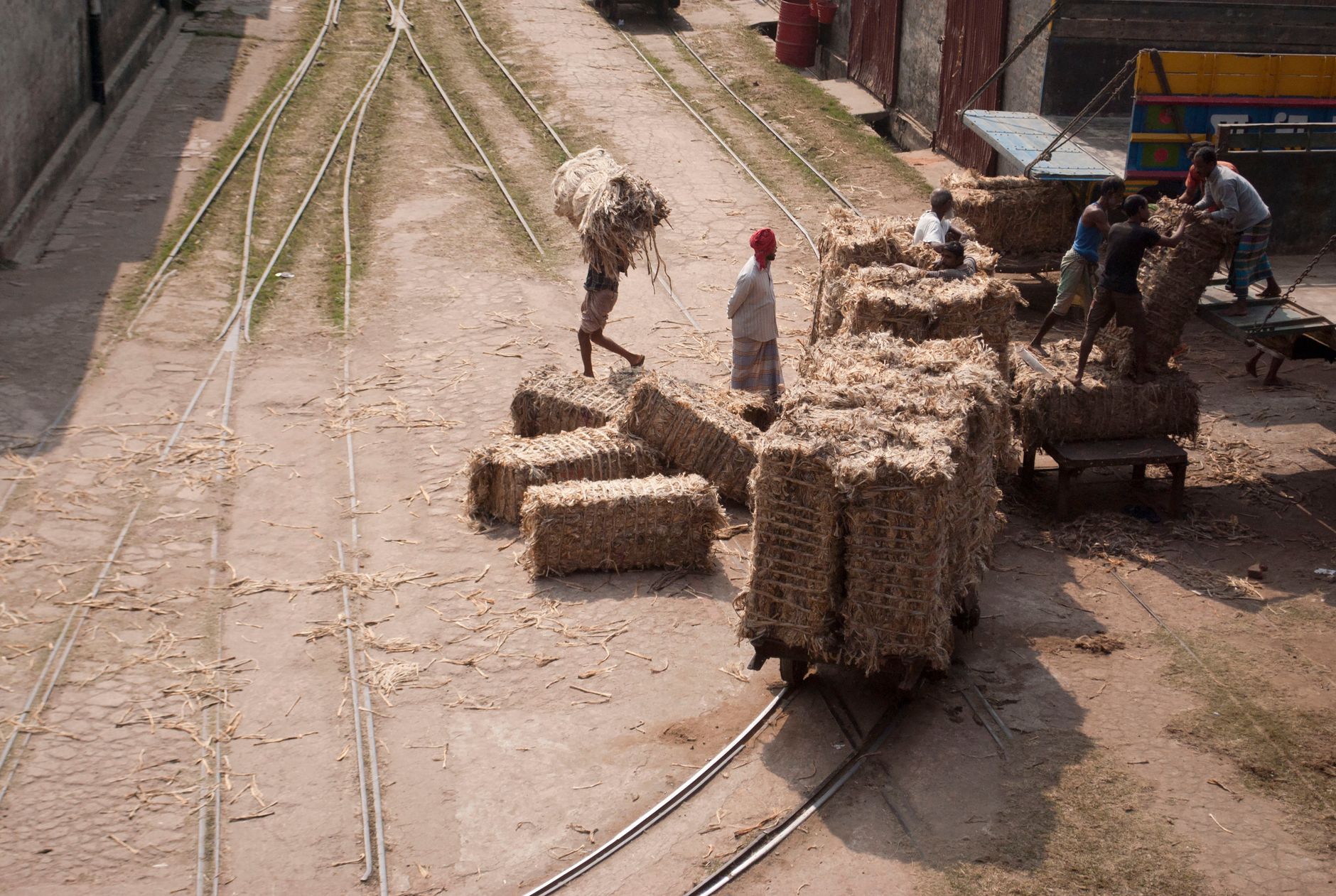 A loading vestibule with flat carts staged near an indoor storage entry, illustrating the operational zones around a rollout pilot.