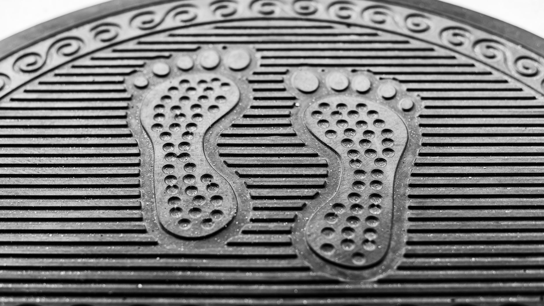 Visible shoe prints mark a glossy showroom floor where surface appearance directly affects the merchandise presentation.