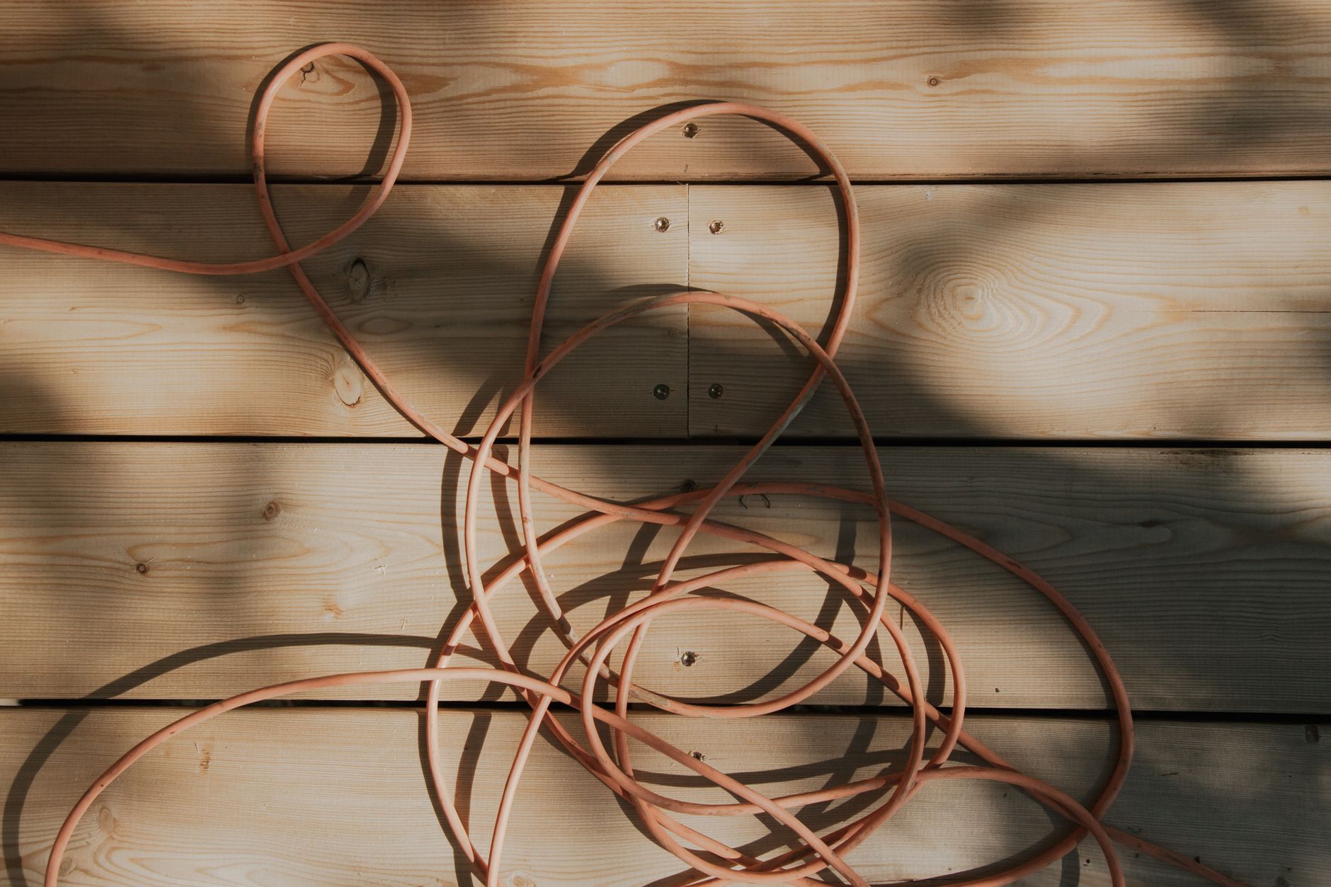 Extension cords stretched across a concrete floor, a common obstacle autonomous scrubbers must clear before a flea market night run.