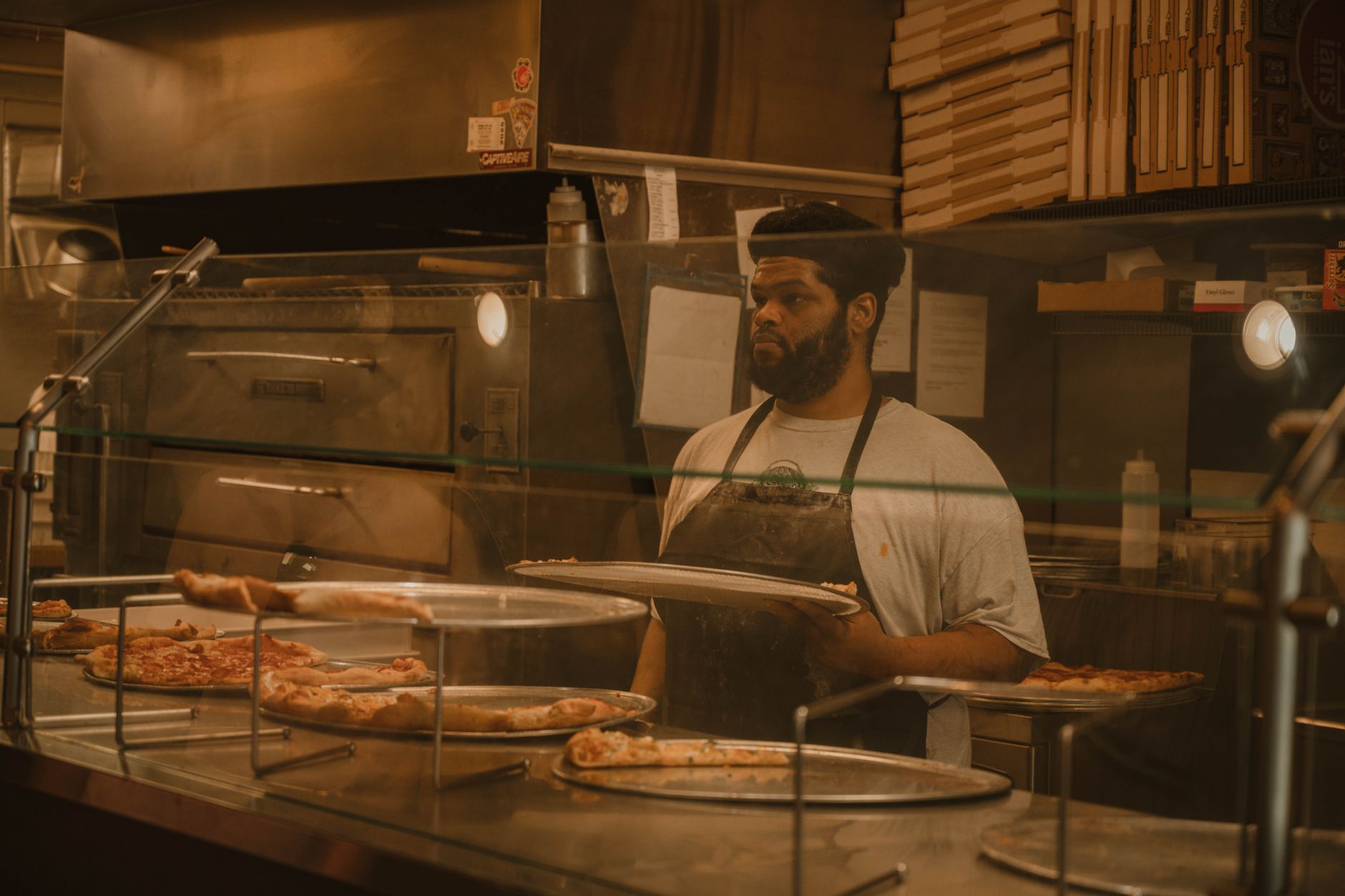 A quick-service snack counter with hard flooring where greasy spills meet the main walkway into an attraction.