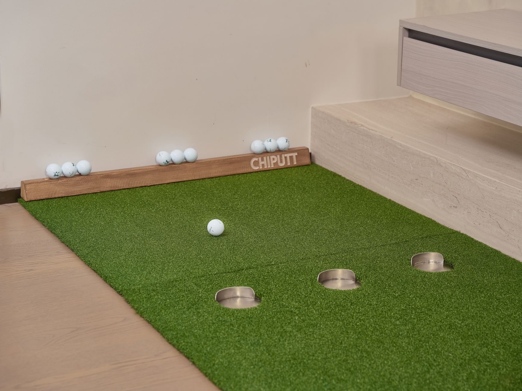 A colorful indoor mini-golf lane with themed obstacles, representing the hard-floor paths a night scrubber must map around props.