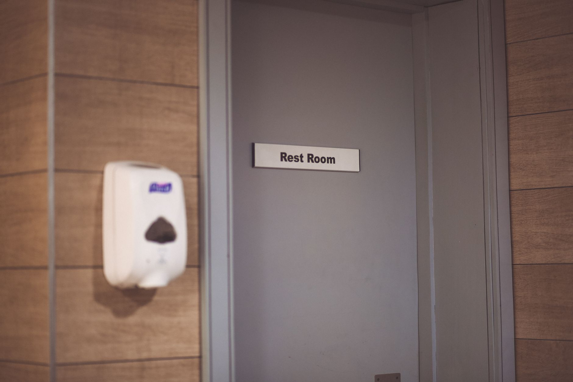 A busy public restroom or corridor entrance with clear walking space, illustrating how layout and bypass room affect guest flow and safety.