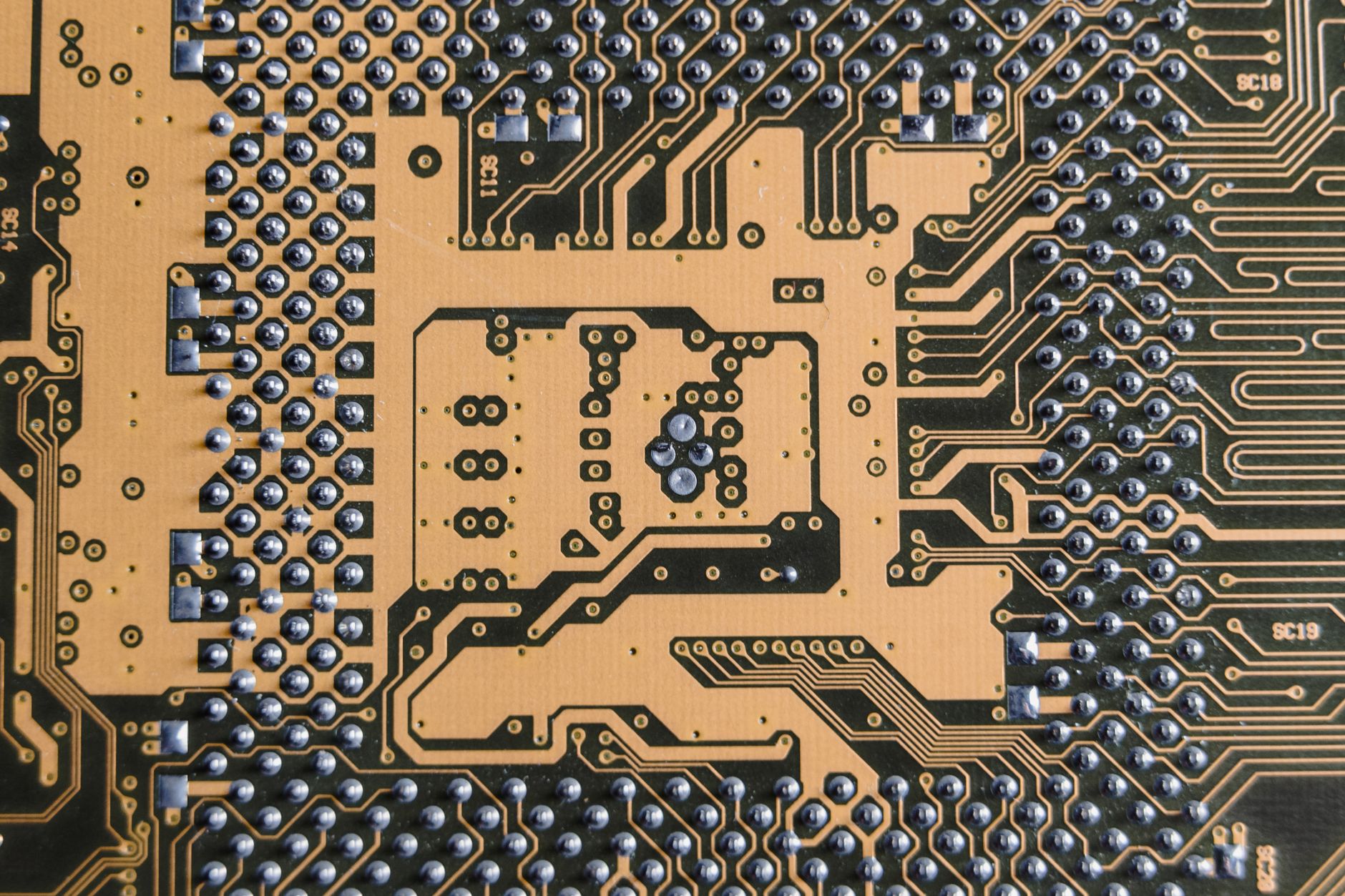 A detailed macro shot of the intricate, iridescent patterns on the surface of a microchip.