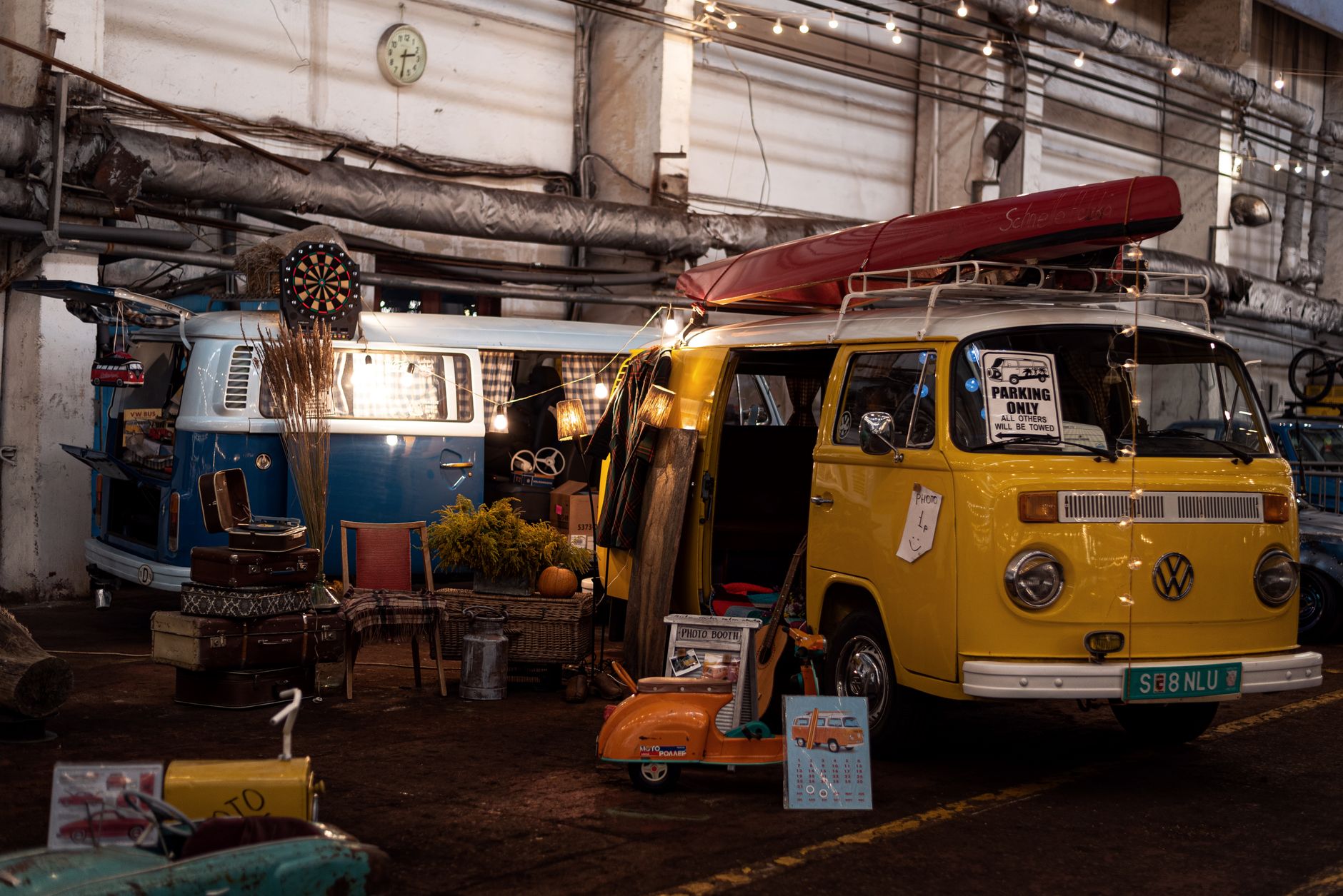 Workers assemble a recreational vehicle inside a spacious production workshop.