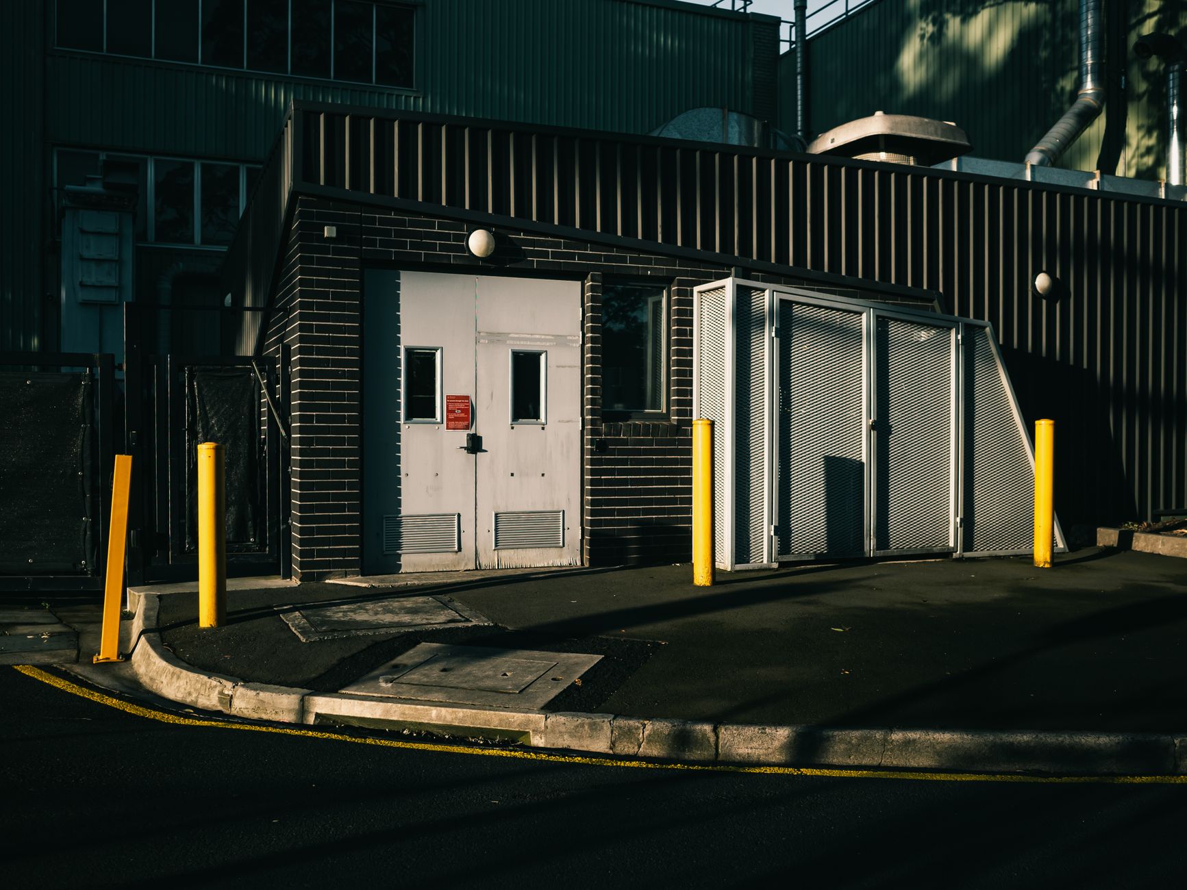 A guarded industrial work area with a safety gate controlling human access.