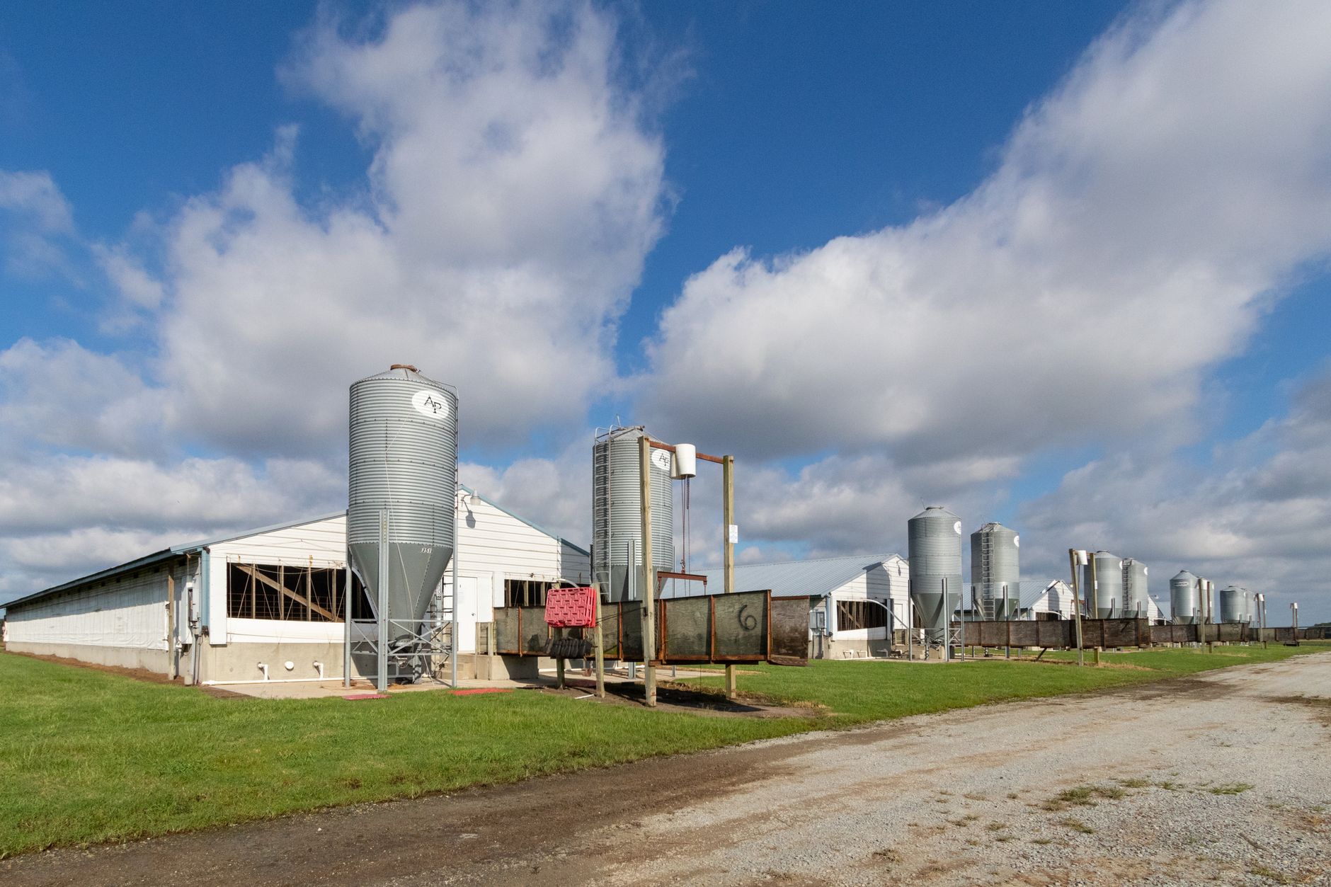 Fine agricultural dust visible around equipment and surfaces inside a feed mill.