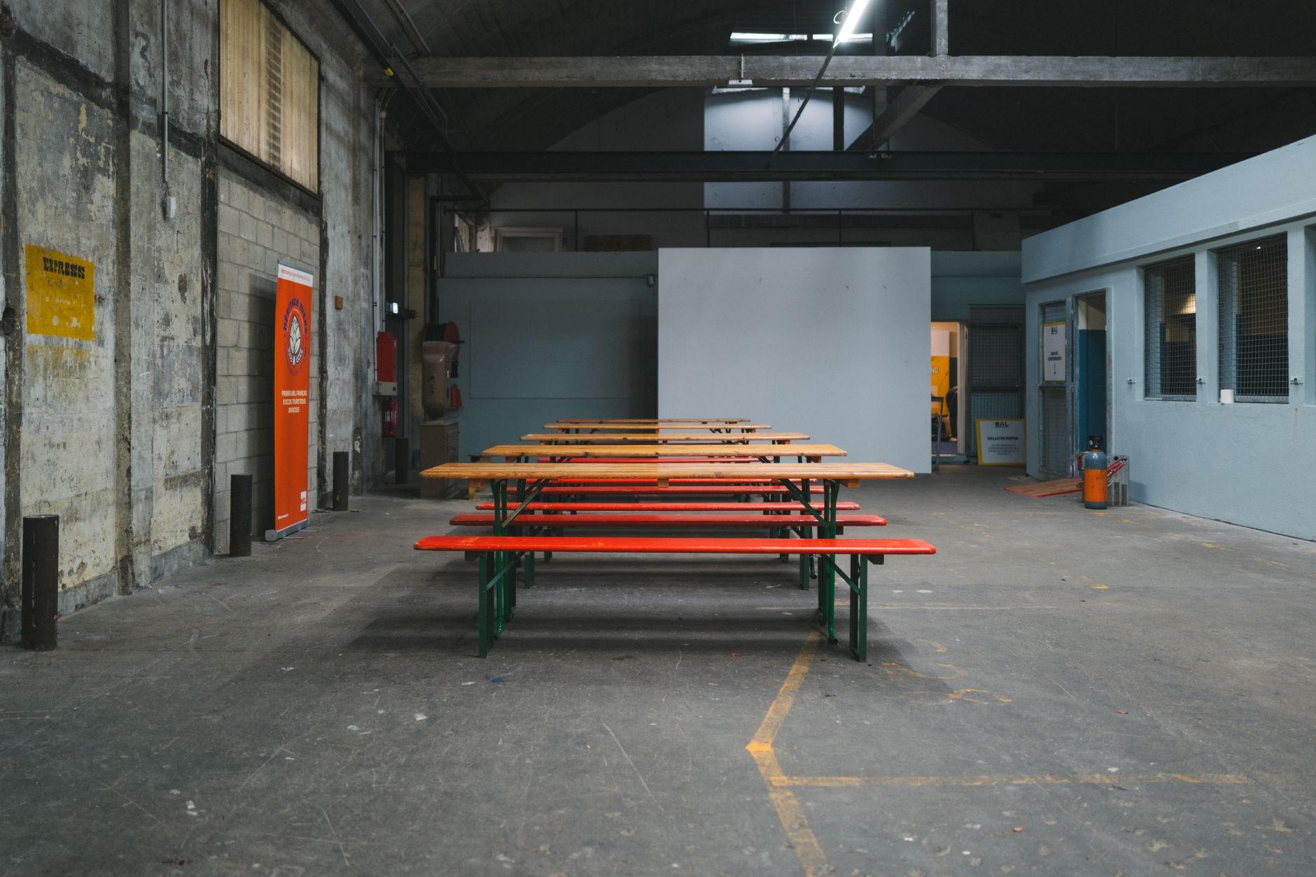 Factory assembly bench with fixtures and hand tools used for repetitive enclosure setups.
