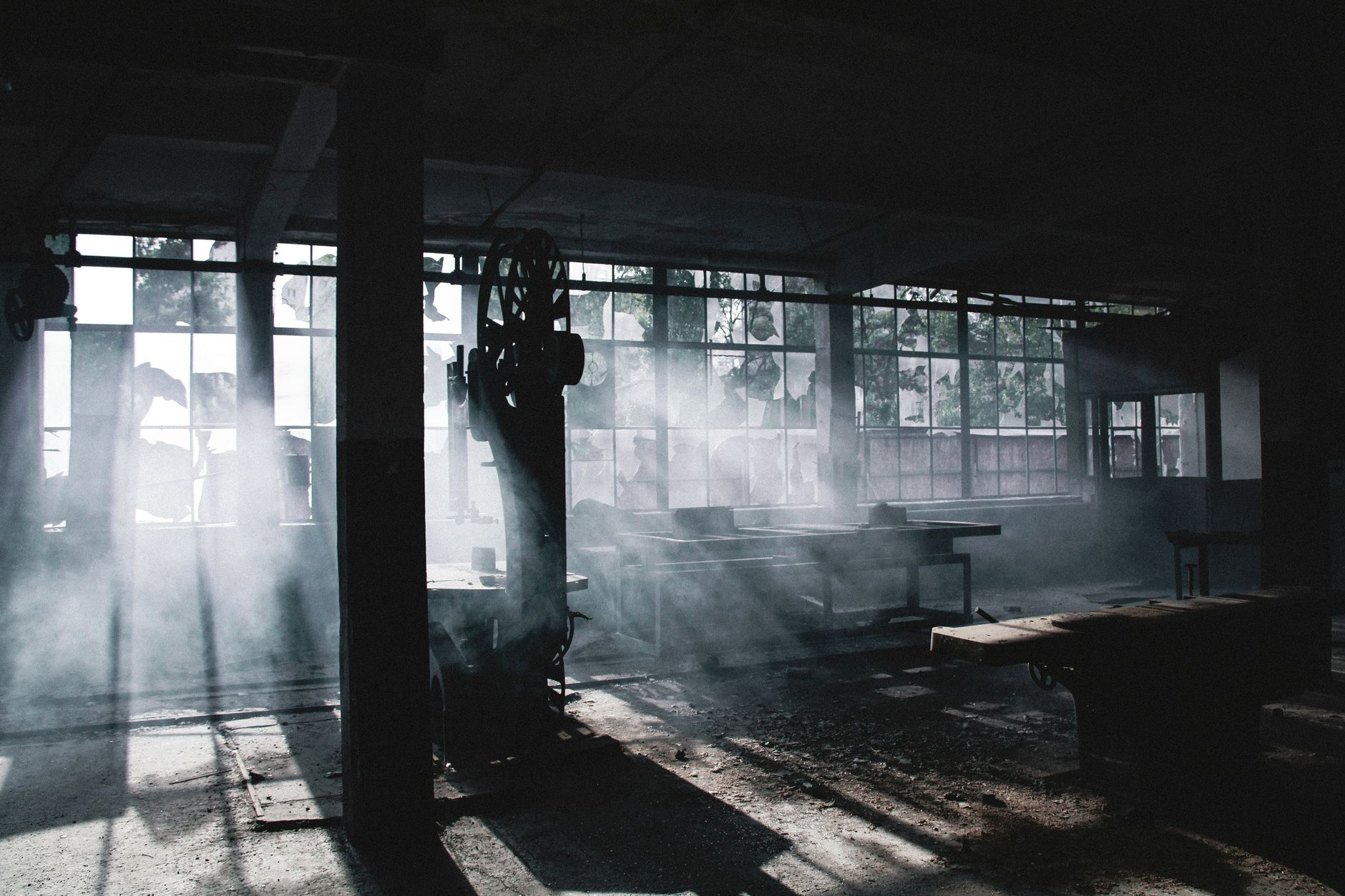 Dust collection hood over a processing station to capture fines during bag cutting and pouring.