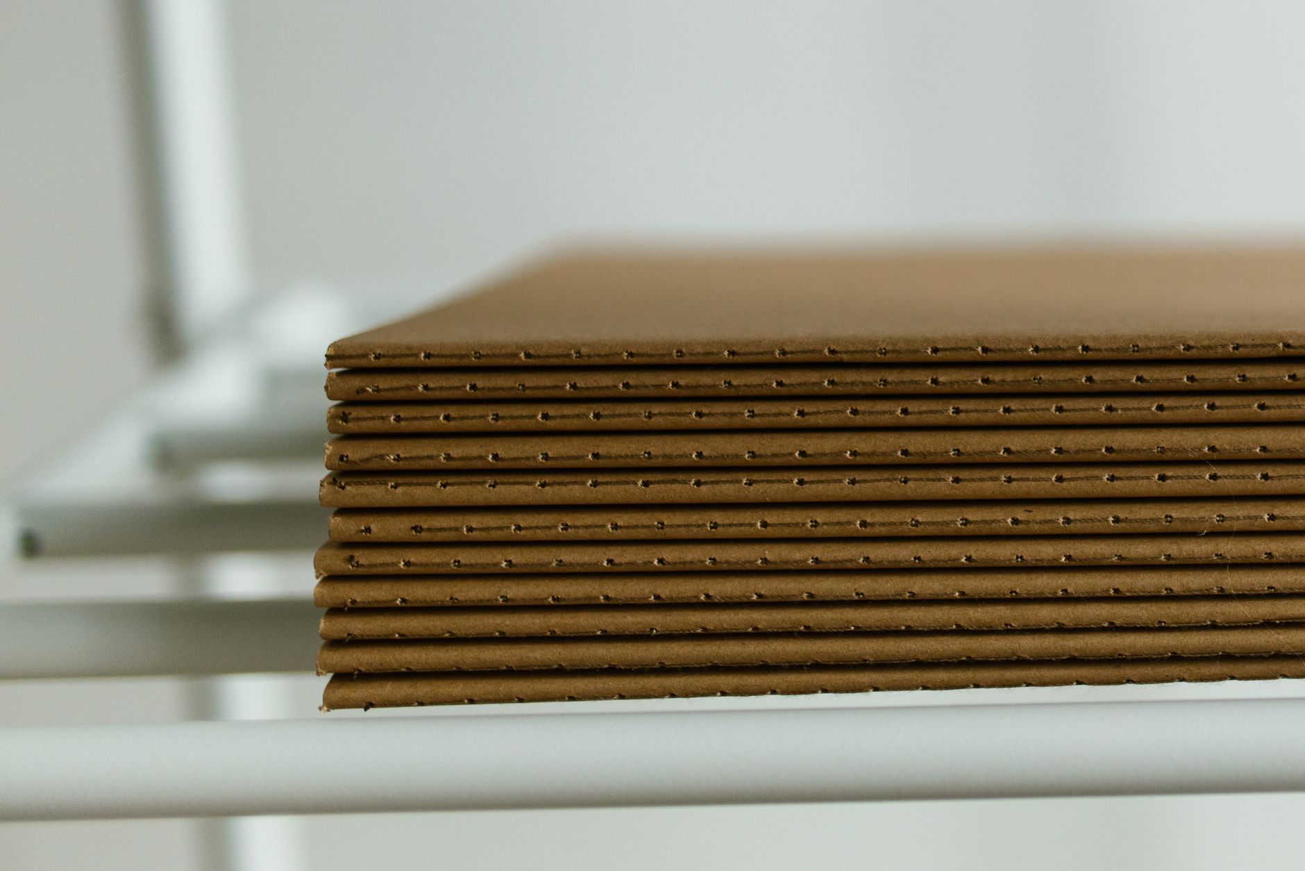 Flat corrugated blanks stacked and labeled, ready for staging before a recipe change on the line.