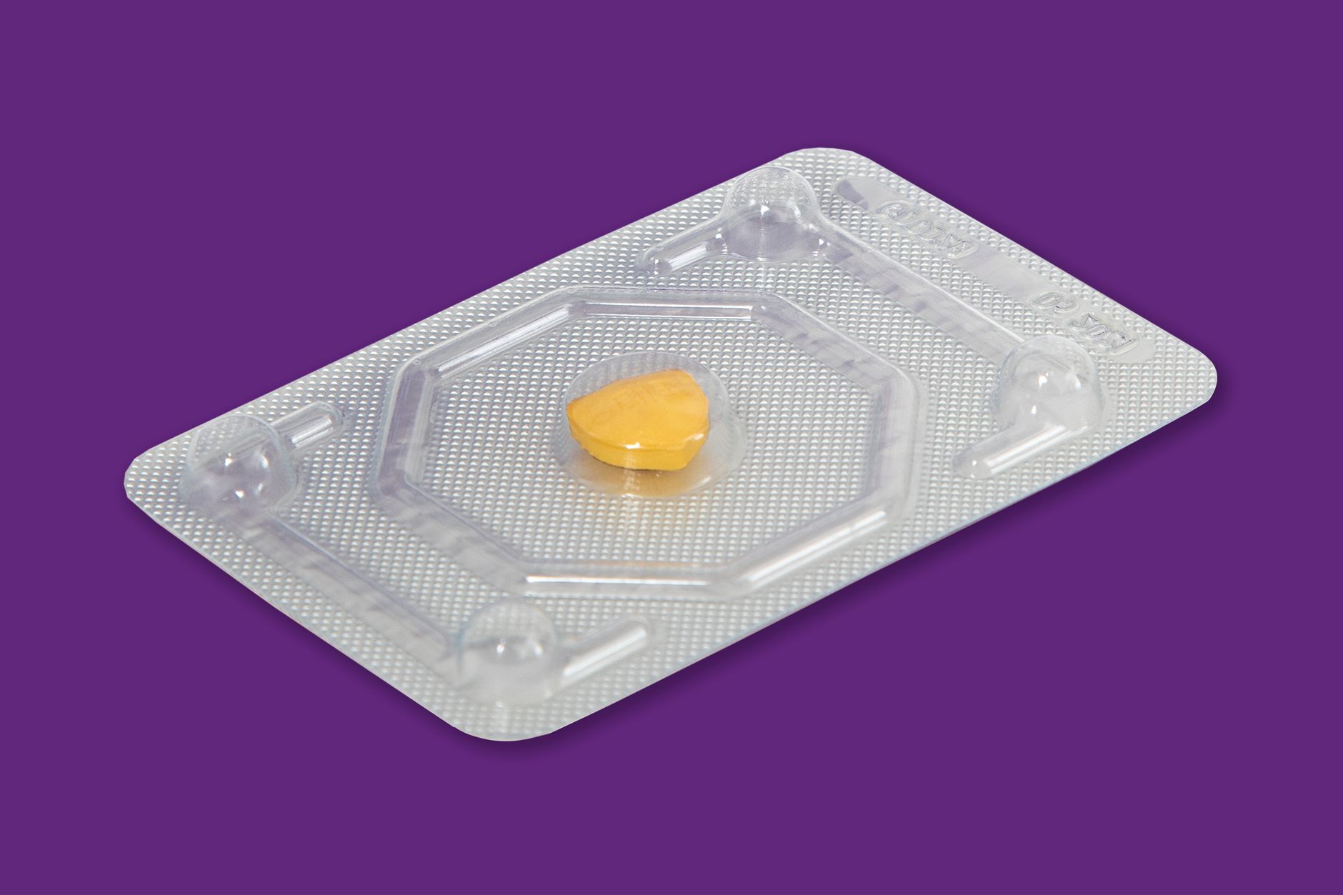 Plastic blister trays staged for automated pick and place into lens packaging nests.
