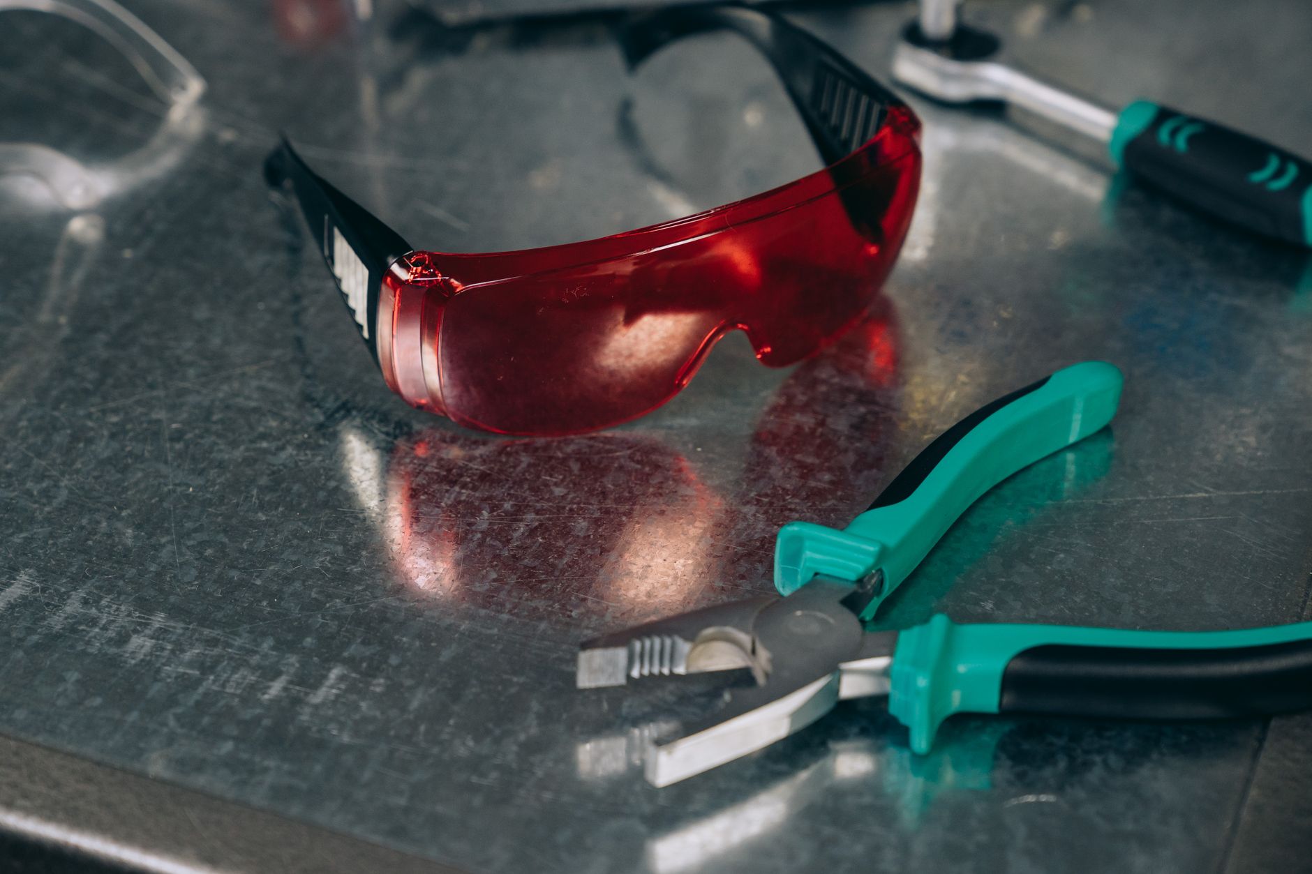 Protective eyewear and a controlled work area, echoing the safety discipline required around a collaborative finishing cell.