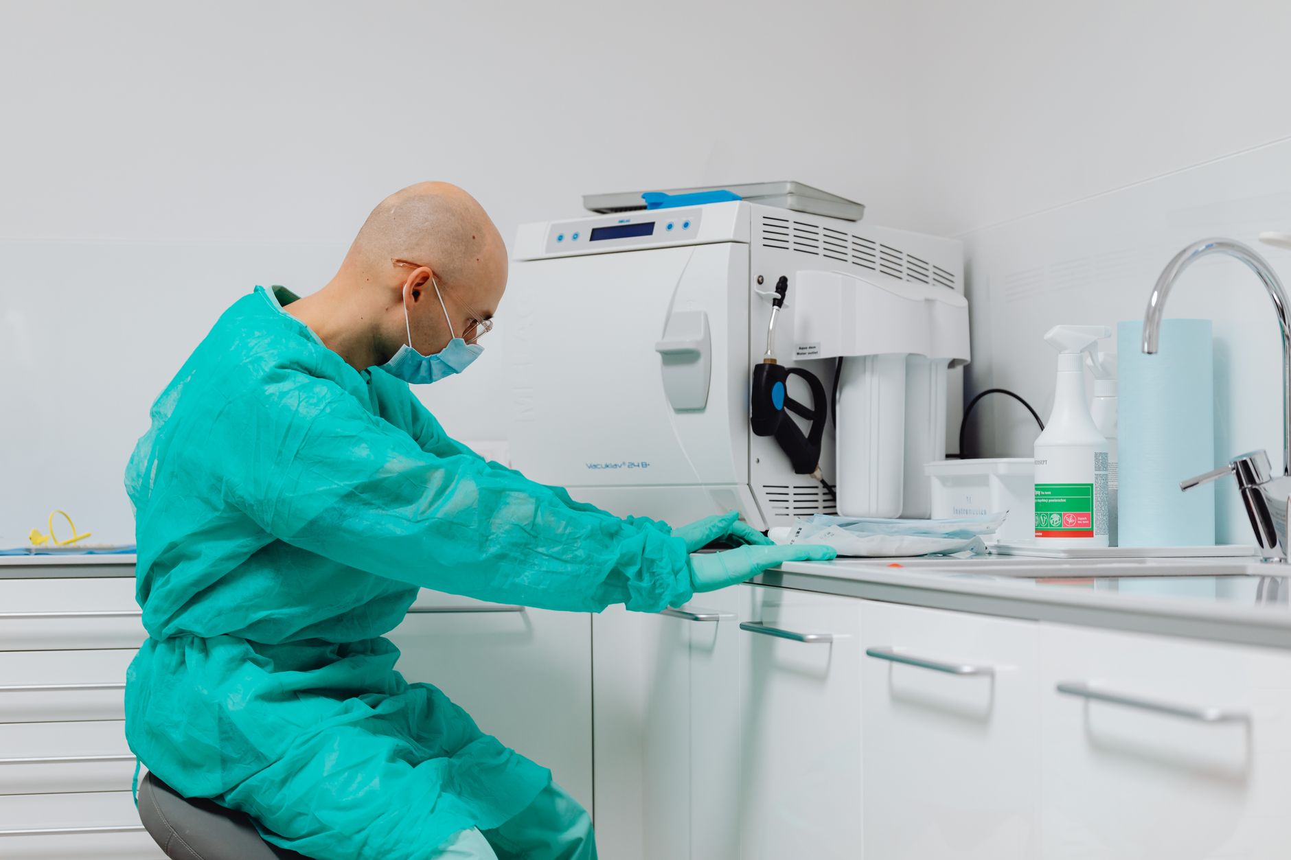 A dental laboratory bench with hand tools and models, representing finishing work before automation assists repetitive passes.