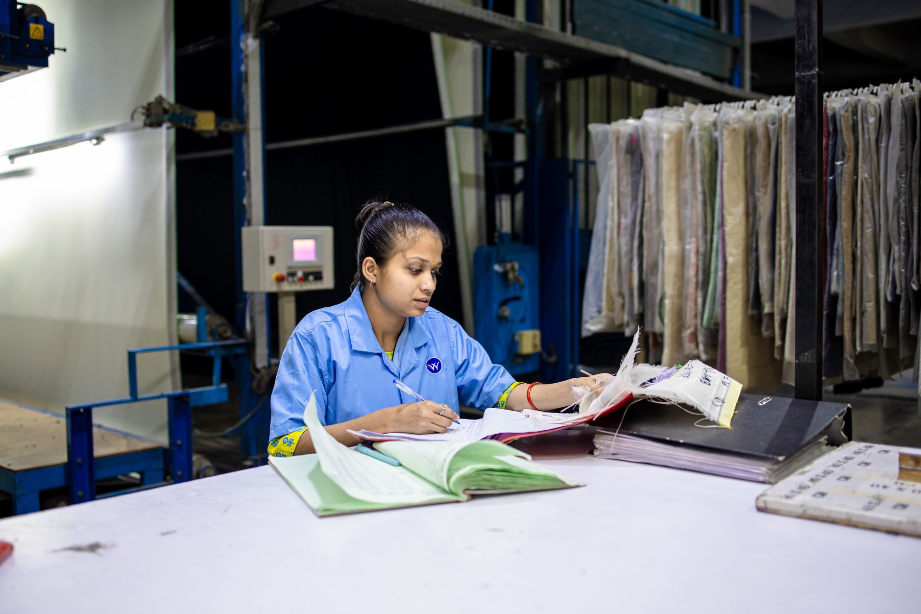 Printed work instructions and parts paperwork laid out at an inspection bench where operators resolve exceptions manually.