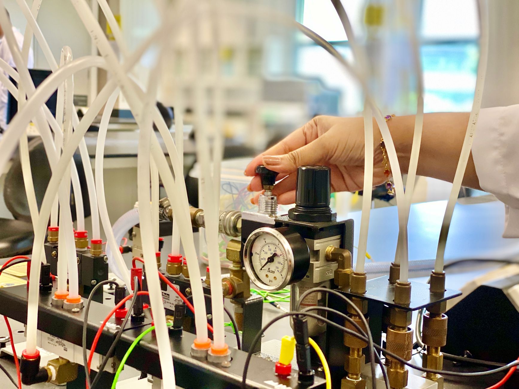 A technician checks a plumbing fixture for leaks during a wet pressure test.