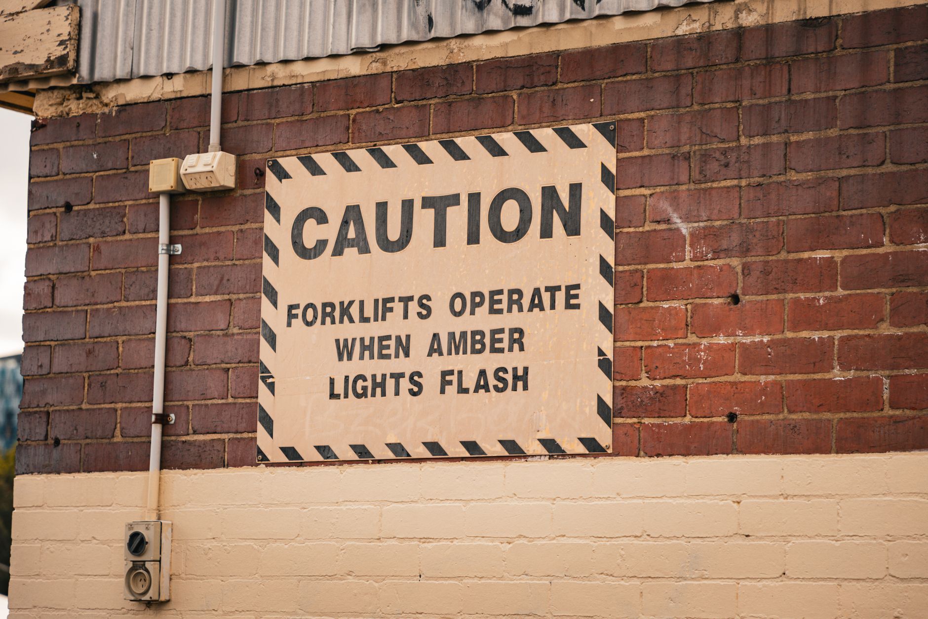 Safety markings in an industrial area where cabinet doors and lifts need hard interlocks with nearby equipment.