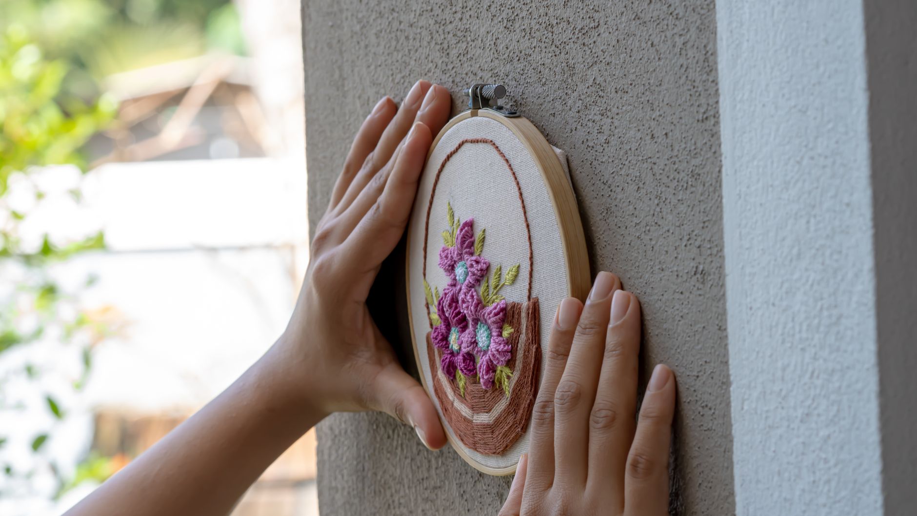 Hoops nested by diameter at a load station beside multi-head embroidery.