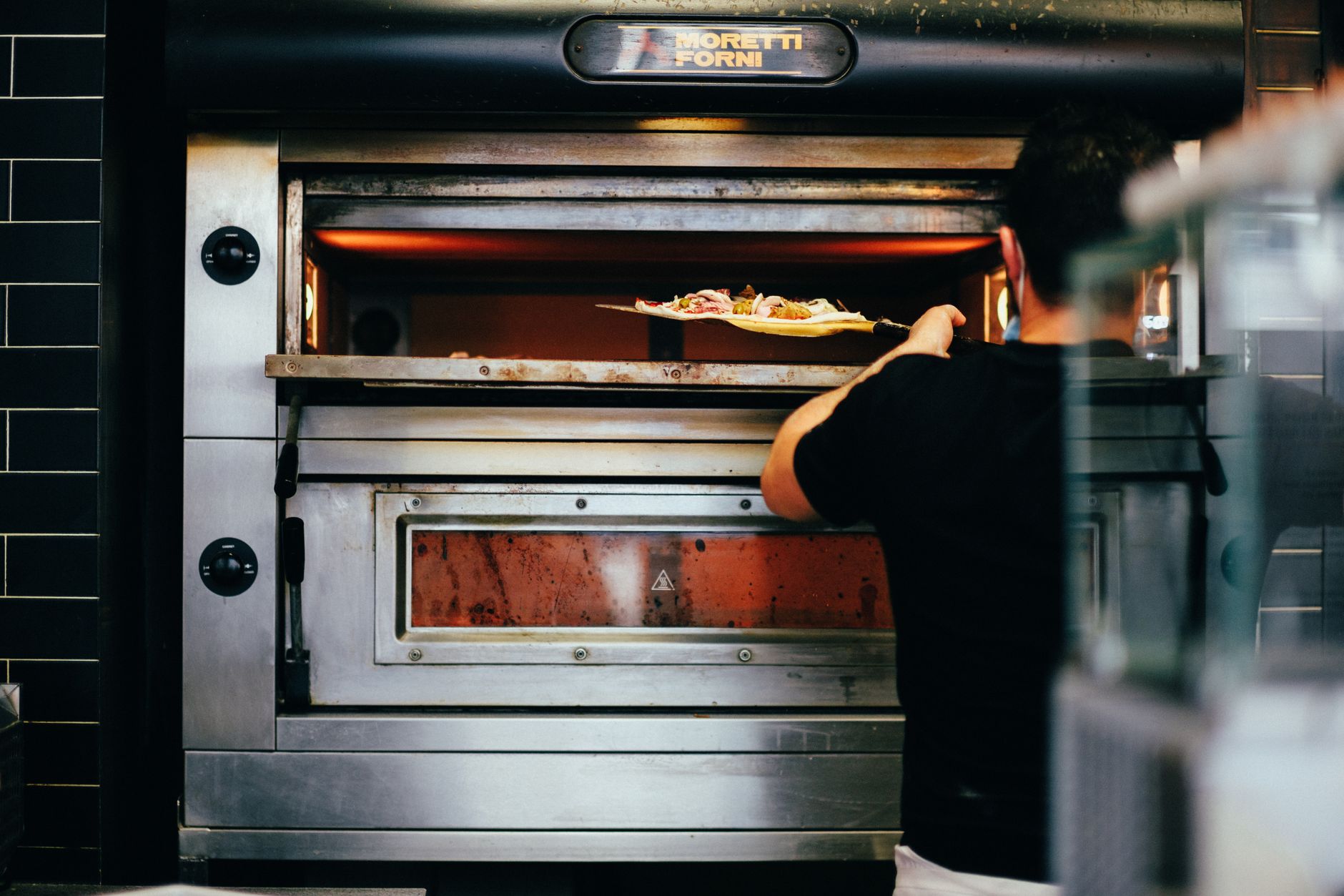 A closed industrial oven-style chamber door, a reminder that interlocks govern when loading can occur.