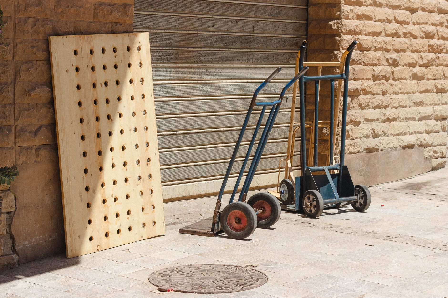 Flat wood panels organized on a cart in a clean shop aisle, showing the kind of stable part presentation a cabinet-shop cell needs.