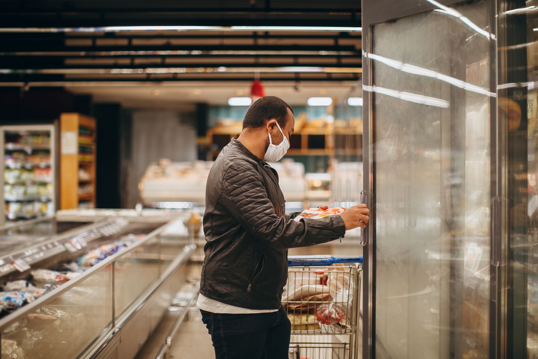 A cold storage aisle with stacked frozen goods, the environment where case palletizing cobots run.