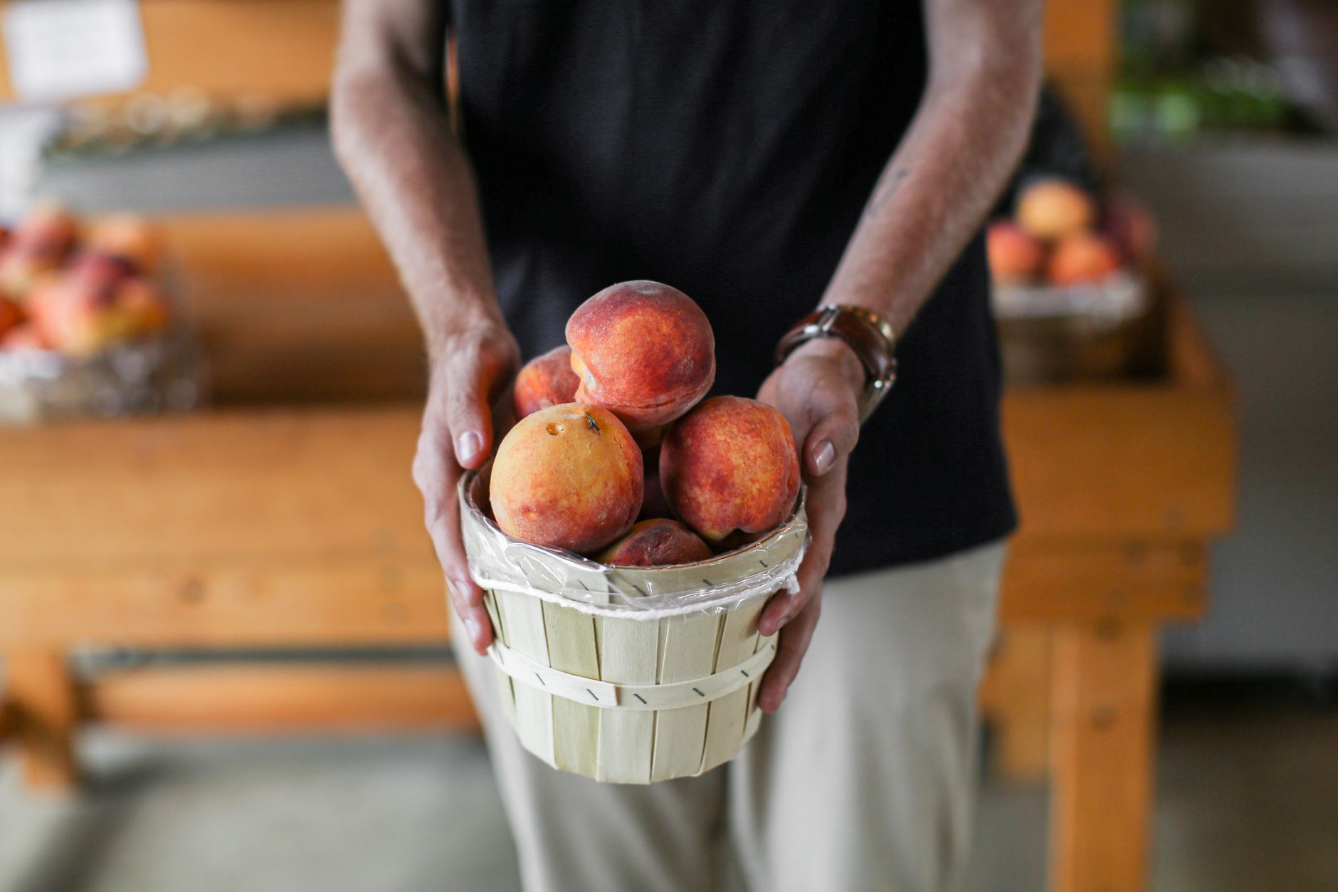 Soft stone fruit in bins, the kind gentle cobot grippers must handle without bruising.